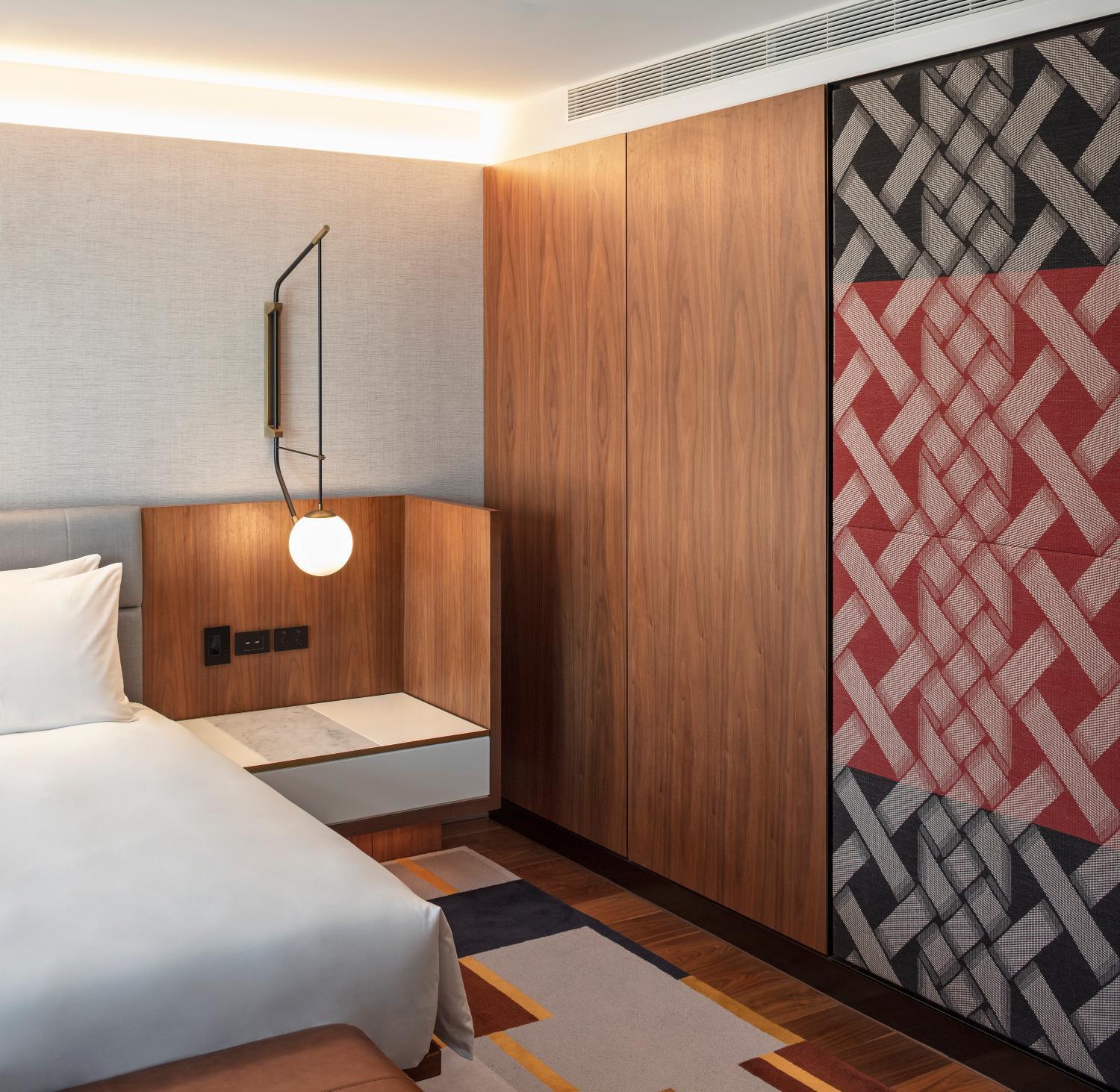 hotel room with a large bed and a colorful wallpaper
