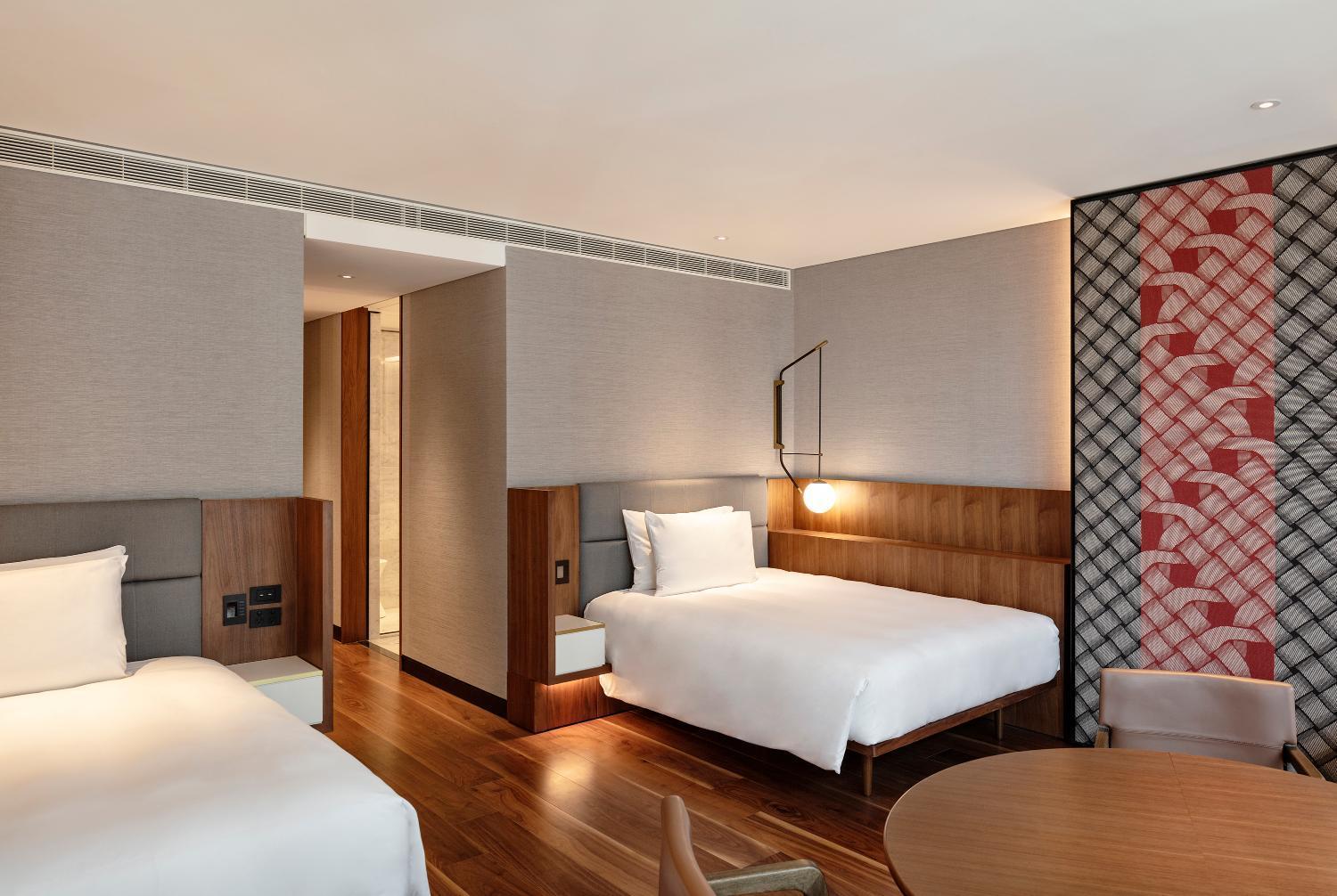 hotel room with two beds, a table and chairs