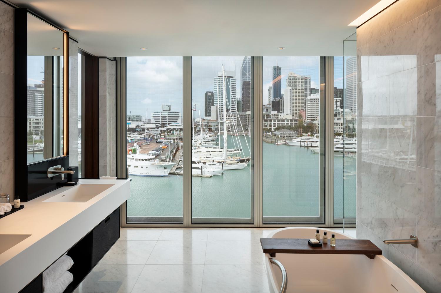 bathtub with a view of the city from it