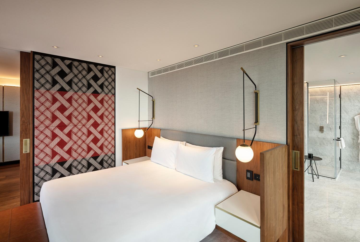hotel room with a king size bed and a walk in shower