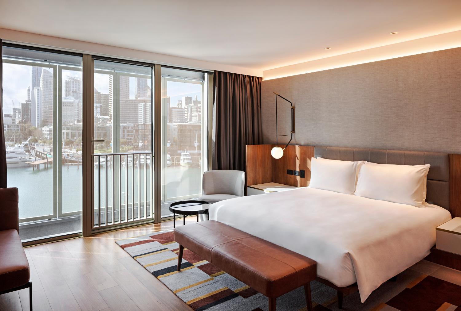 hotel room with a view of the water and city