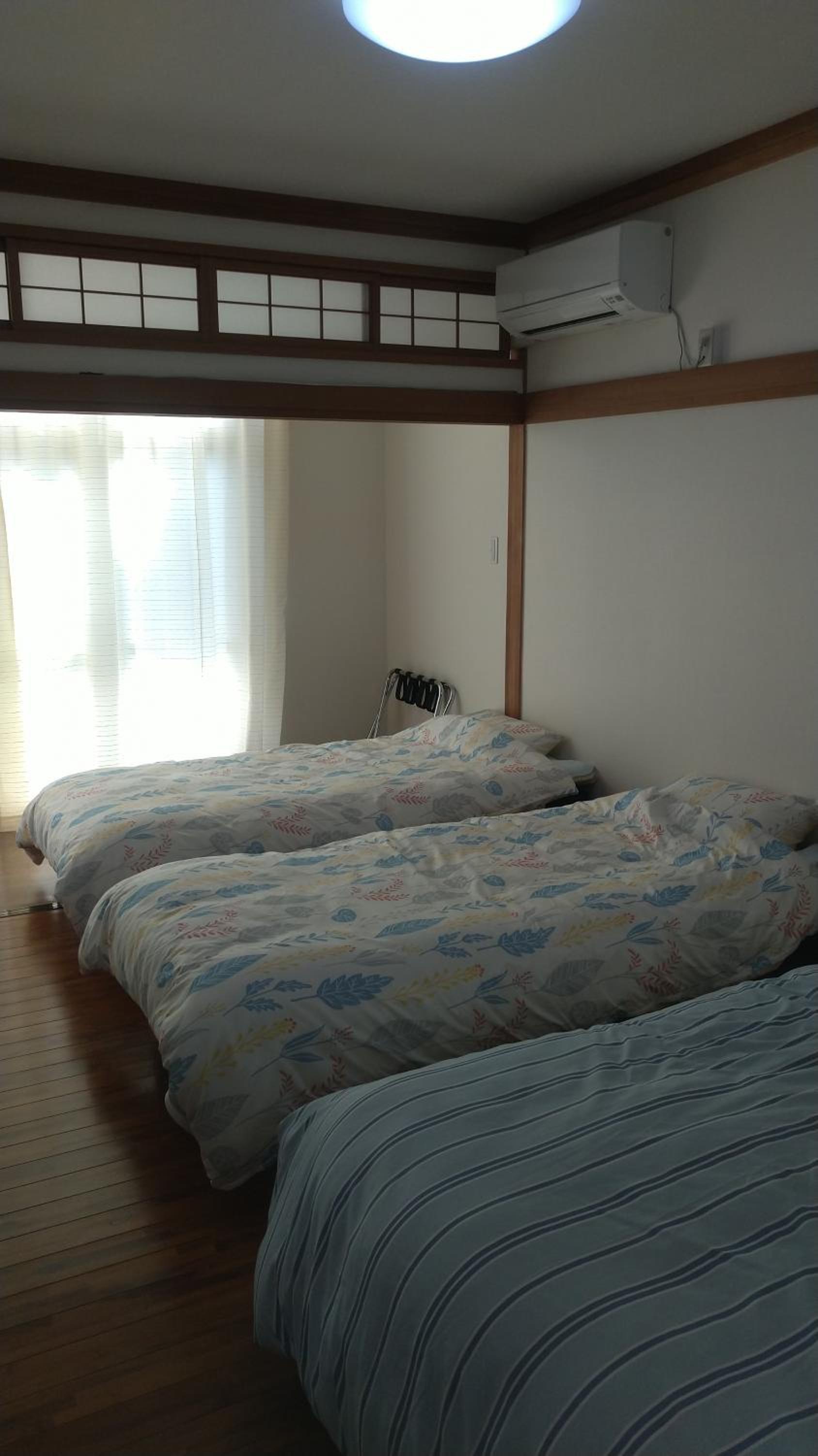 Quadruple Room with 2 Single Beds and 1 Double Bed - Photo 1