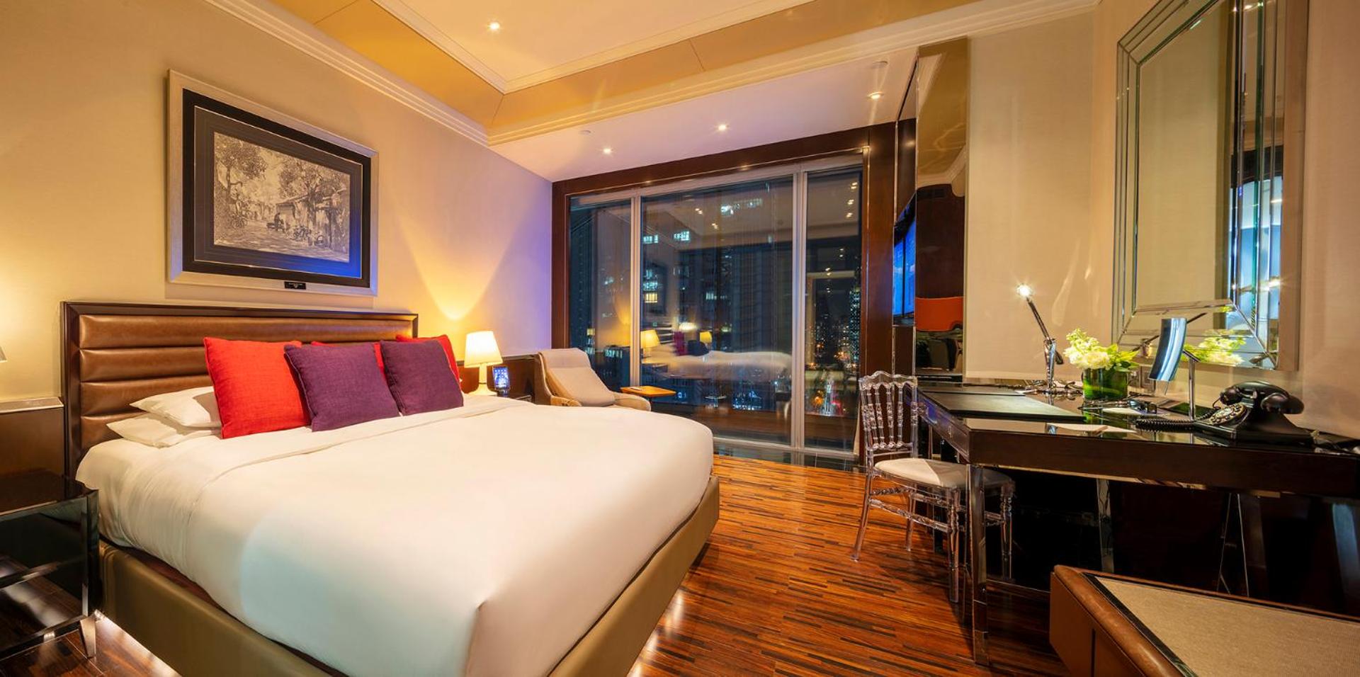 hotel room with a bed, desk, and chair