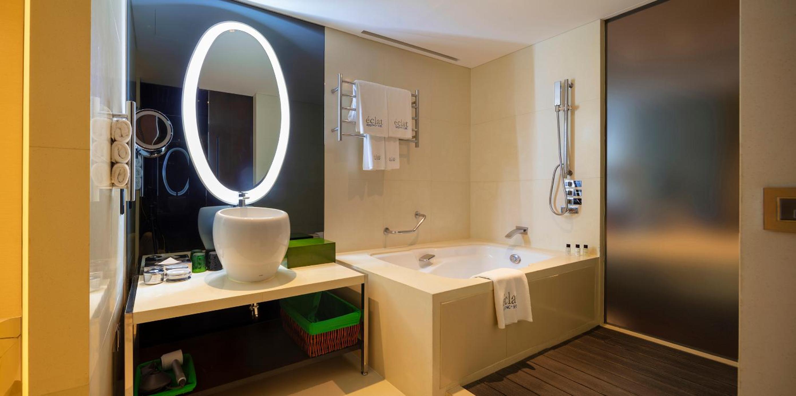 bathroom with a bathtub, sink, and mirror