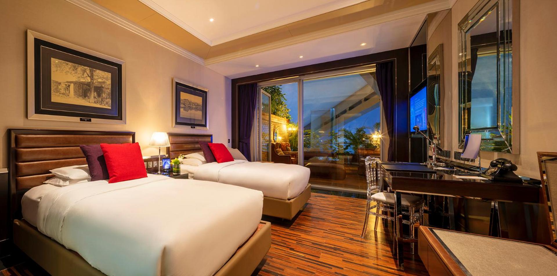 hotel room with two beds and a view of the ocean