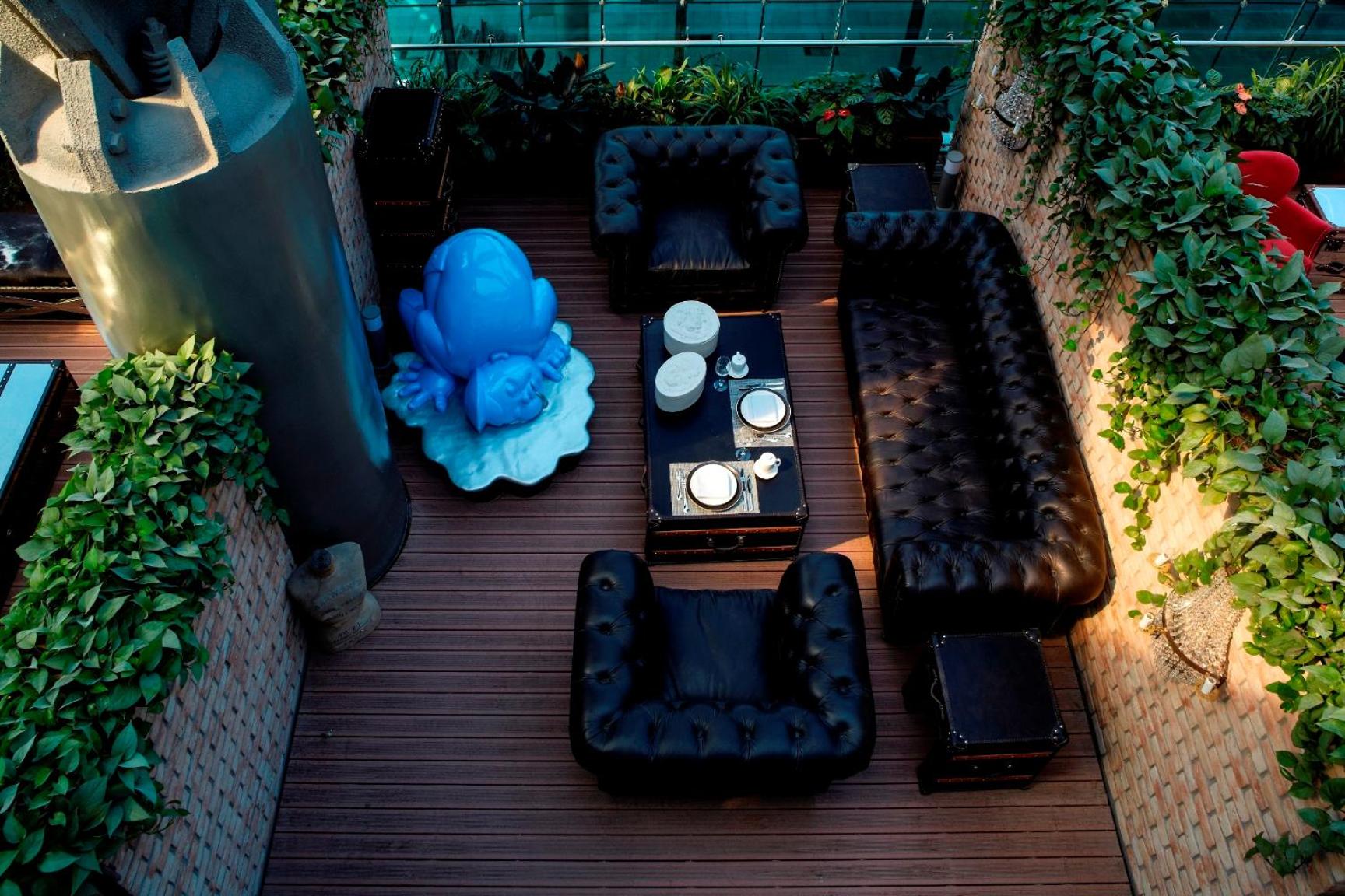 view from above of a patio with black leather furniture