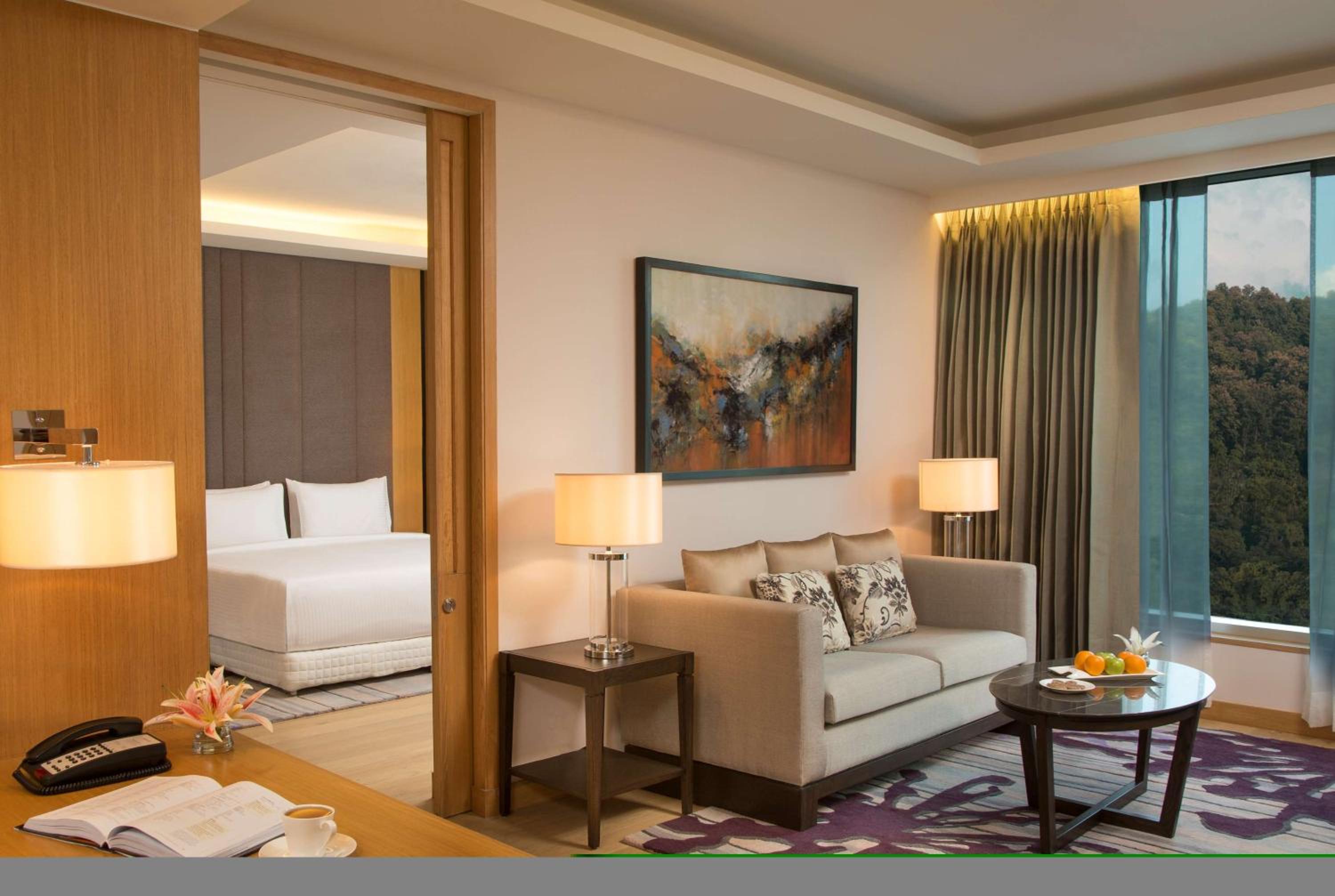 Suite Bedroom with separate living room & bed room with King bed, Bath tub , 2 way airport transfer, bottle of complimentary House wine , 15% discount on Food & Soft Beverages and Pick up and drop from Kamakhya Temple photo 3