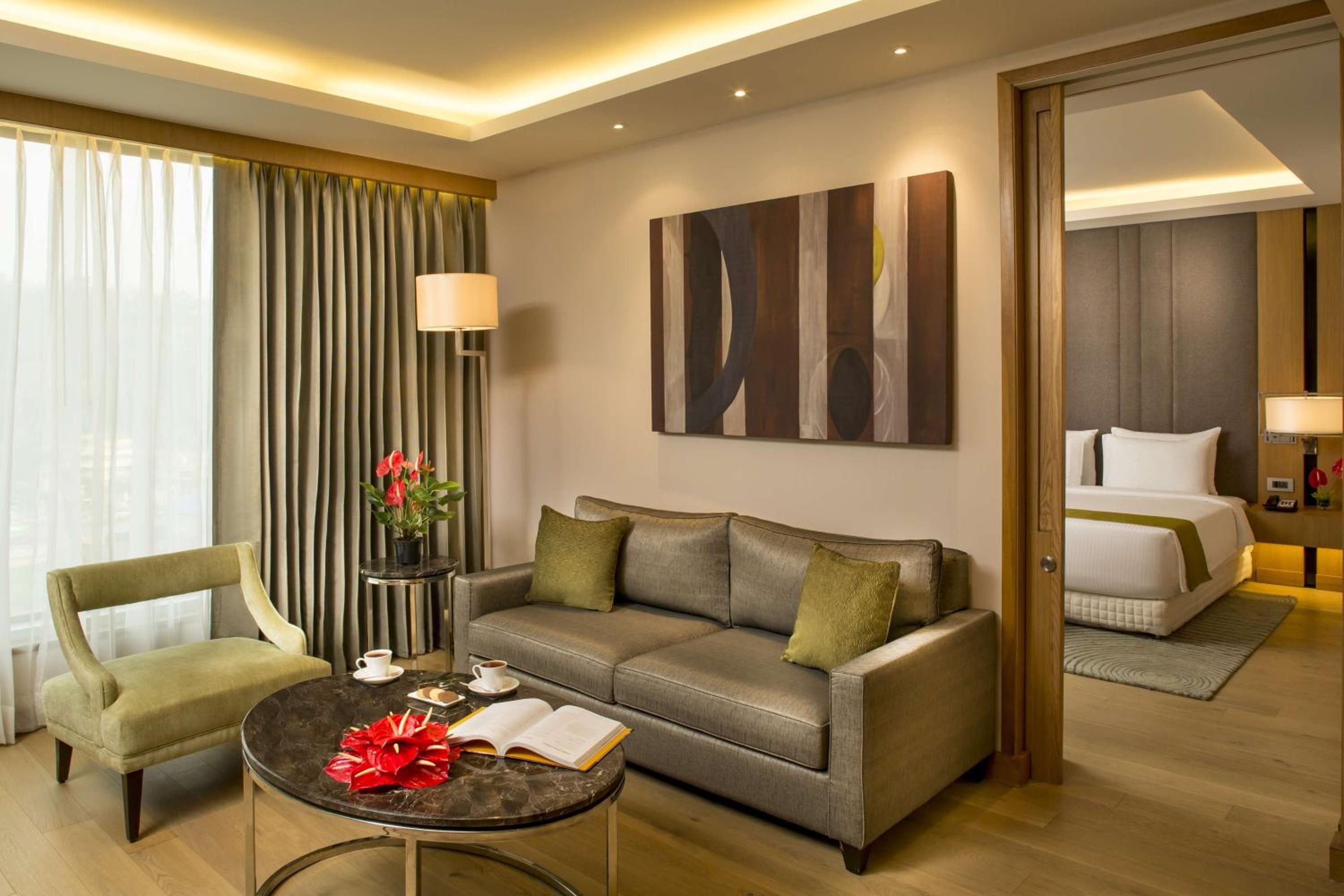 Suite Bedroom with separate living room & bed room with King bed, Bath tub , 2 way airport transfer, bottle of complimentary House wine , 15% discount on Food & Soft Beverages and Pick up and drop from Kamakhya Temple photo 2