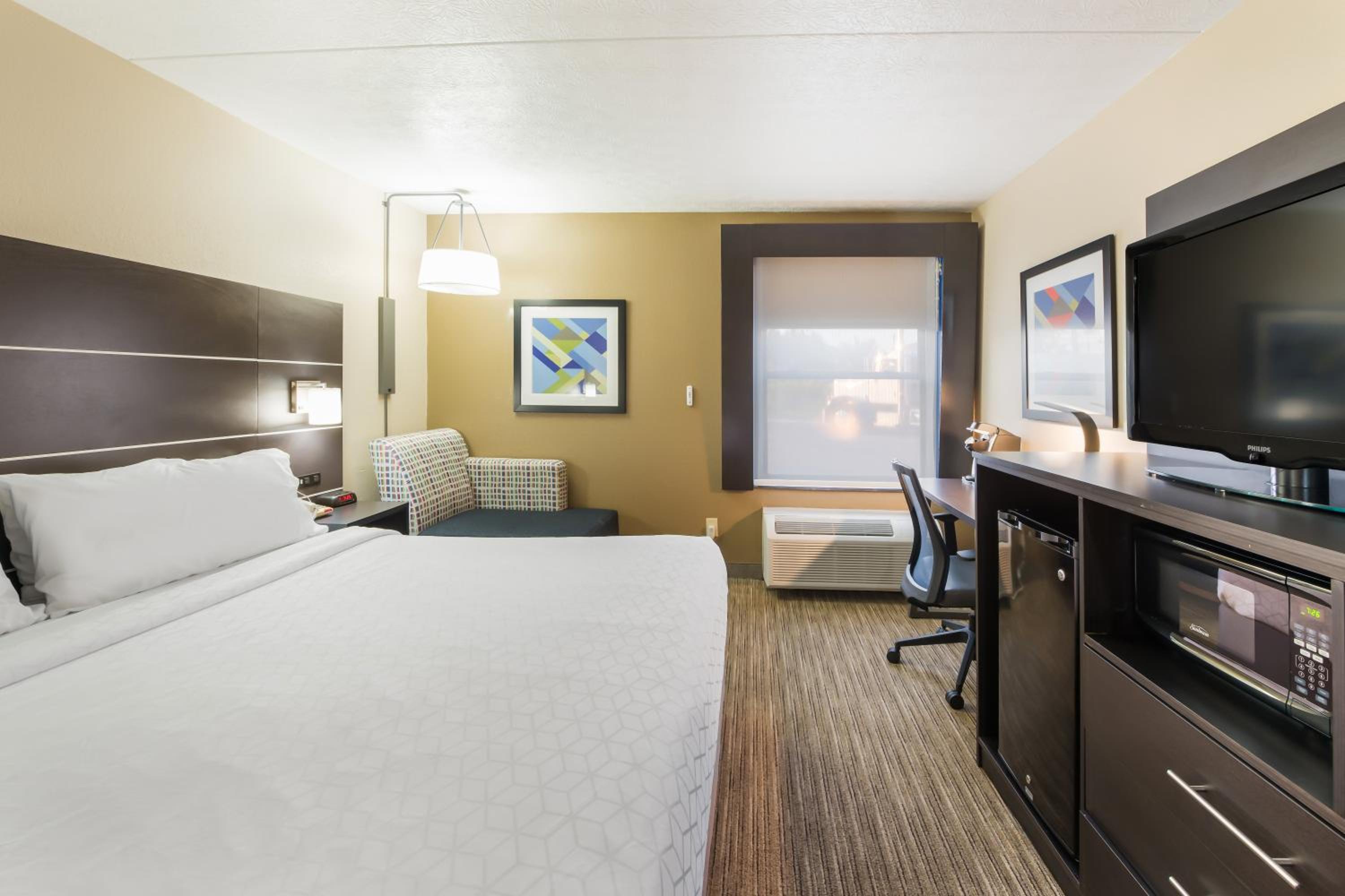 hotel room with a king size bed and flat screen tv