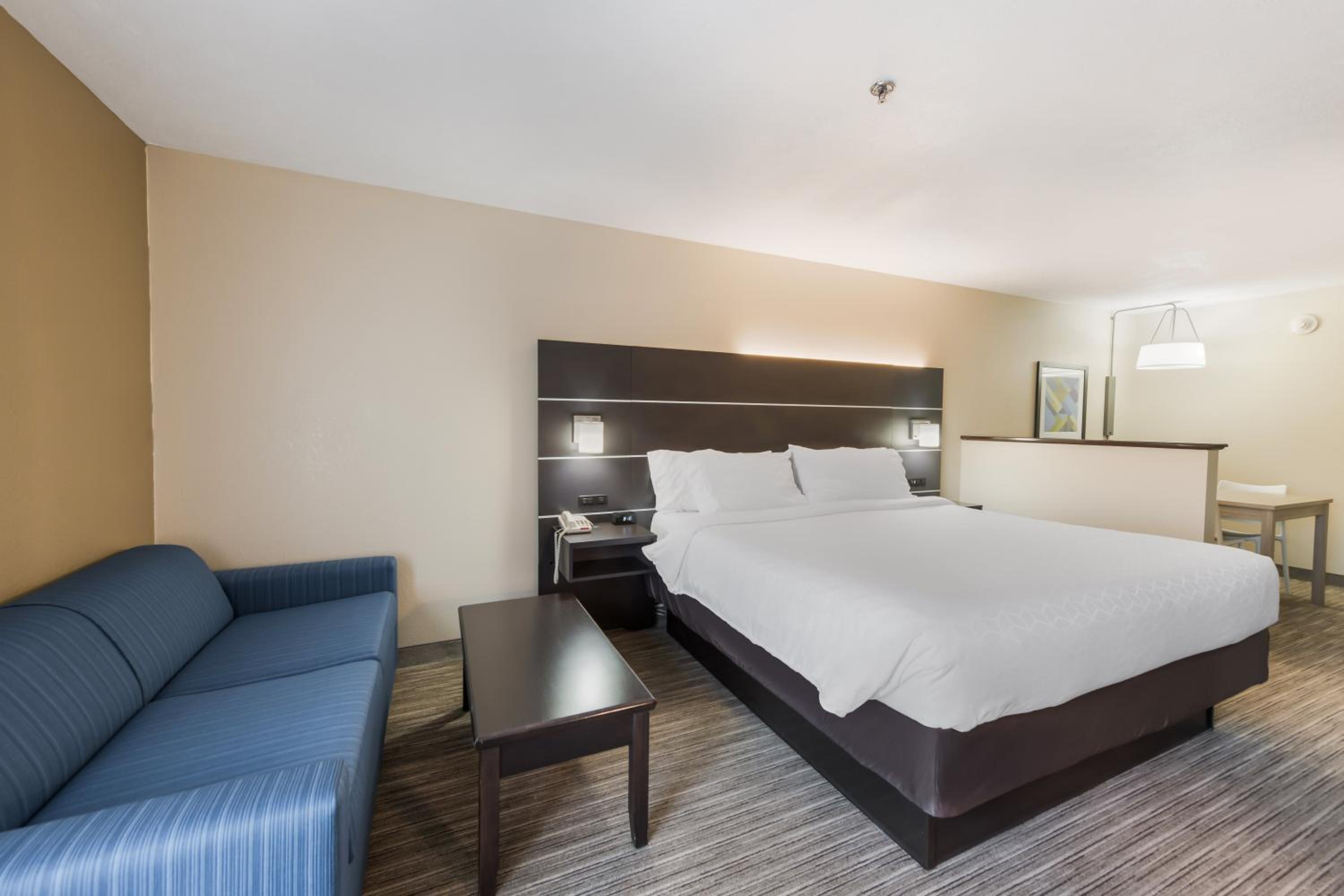 hotel room with a king size bed and a sofa