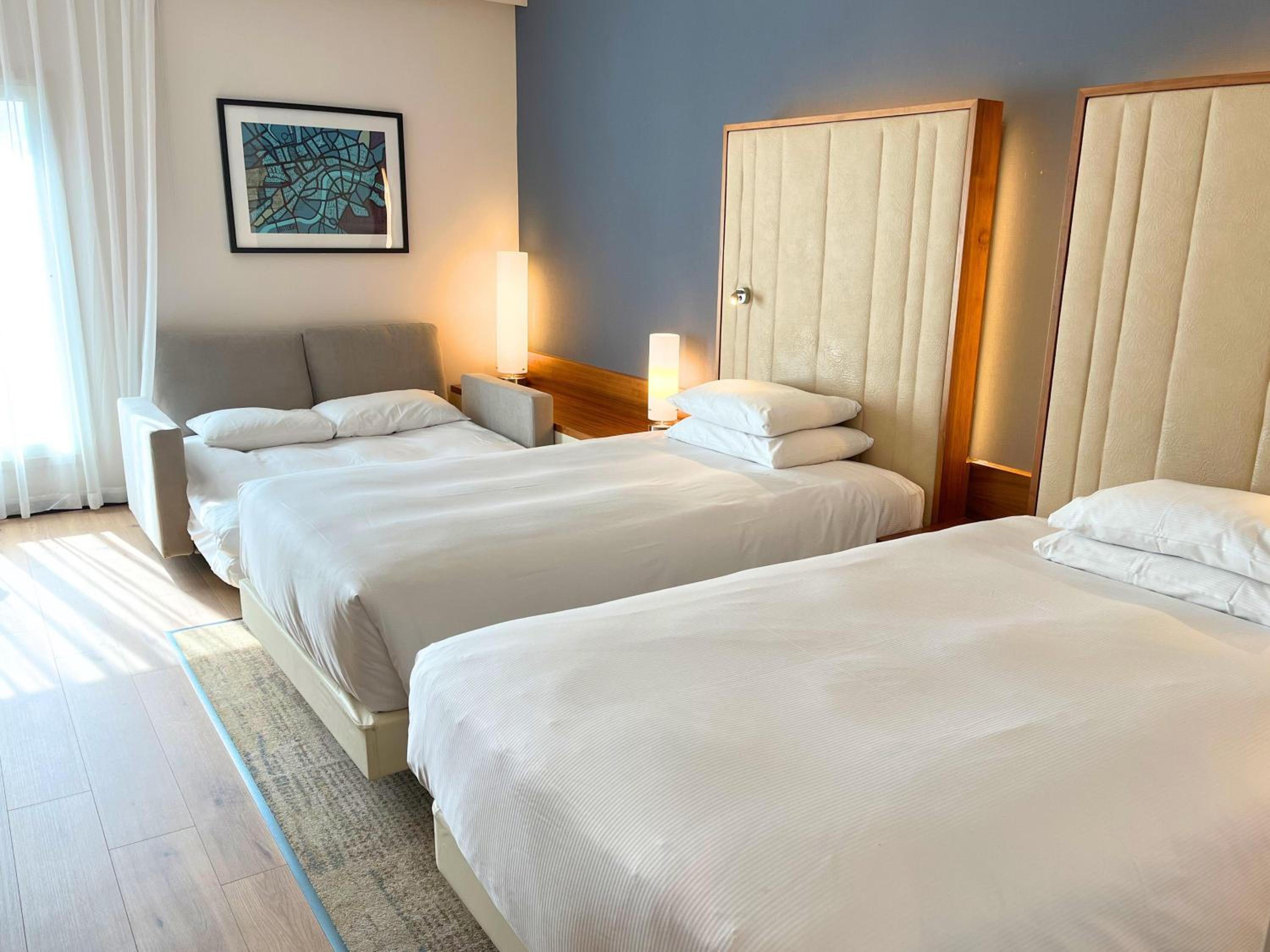 Family Room with Two Twin Beds and One Double Sofa Bed