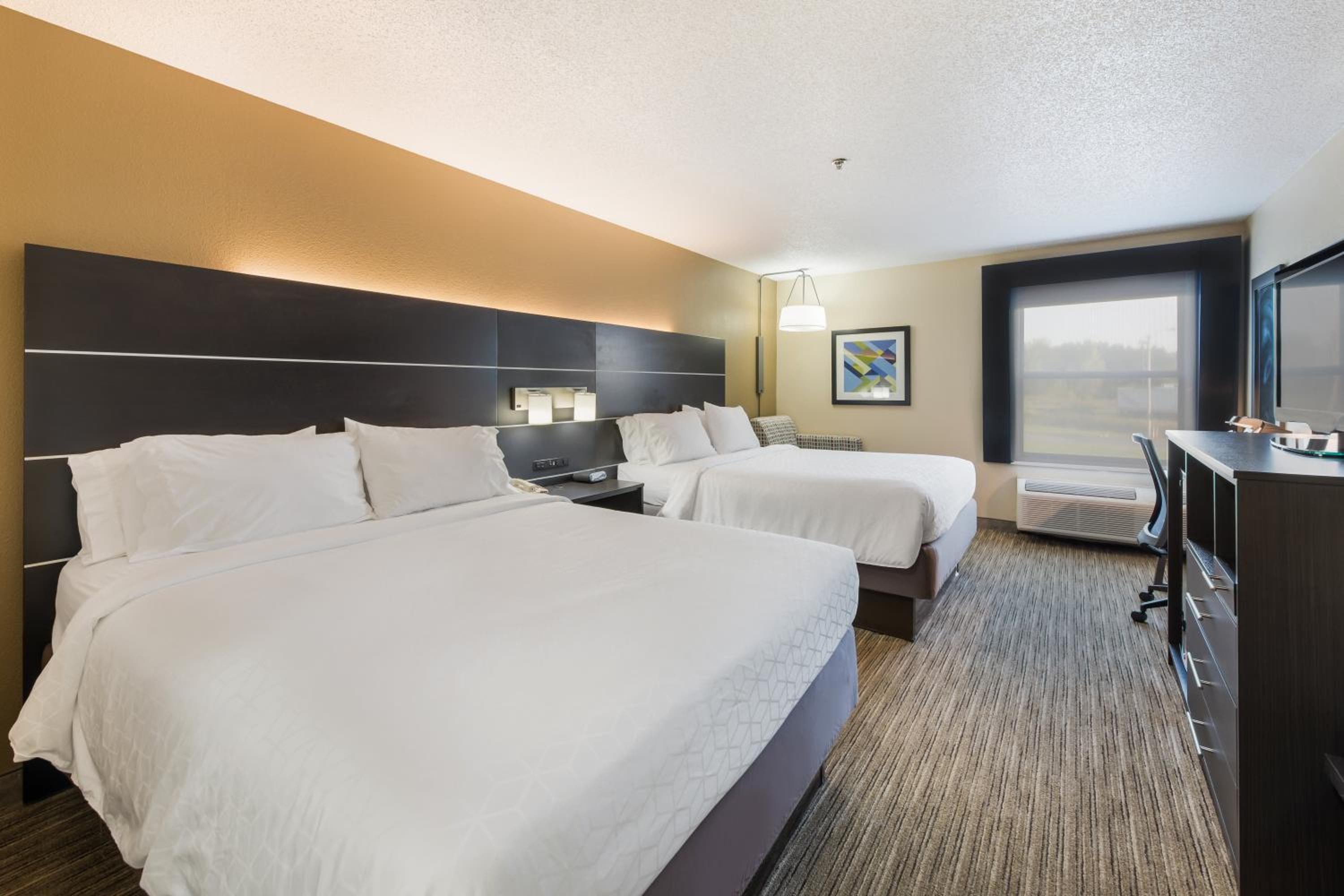 hotel room with two beds and a flat screen tv