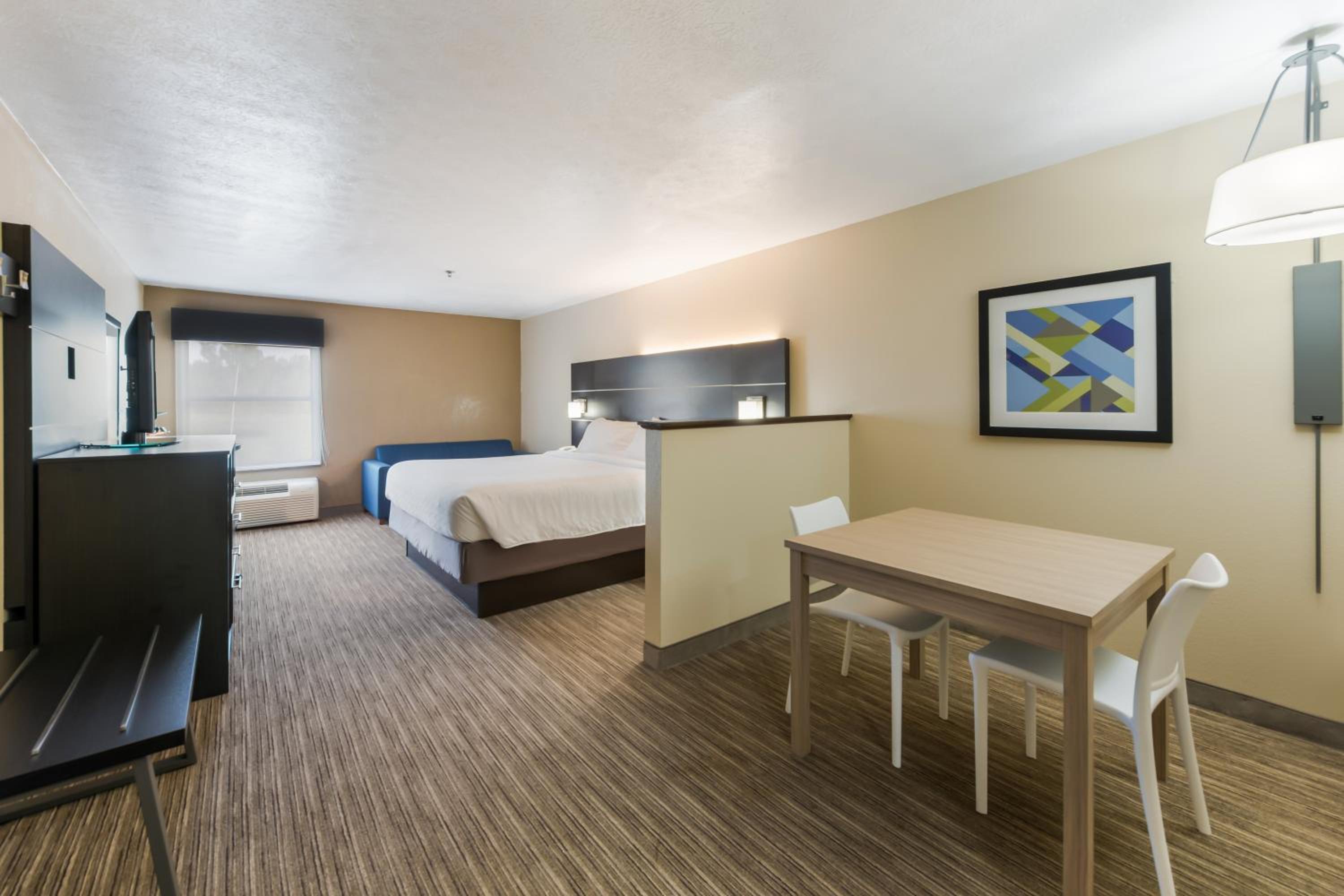 hotel room with two beds and a small dining table