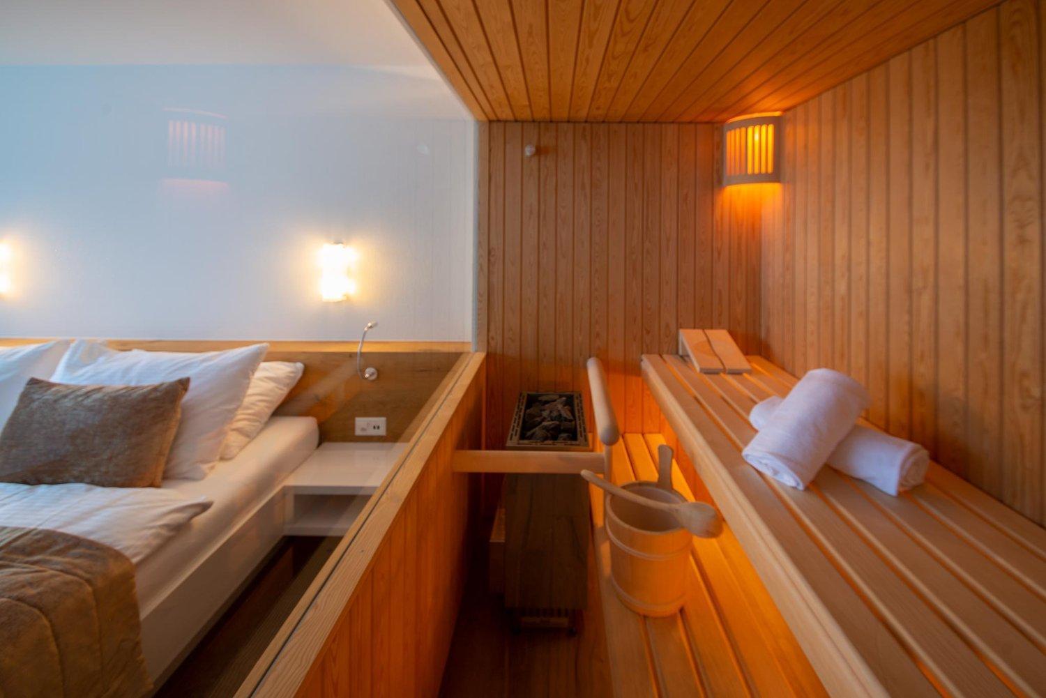 sauna room with a bed and a wooden bench
