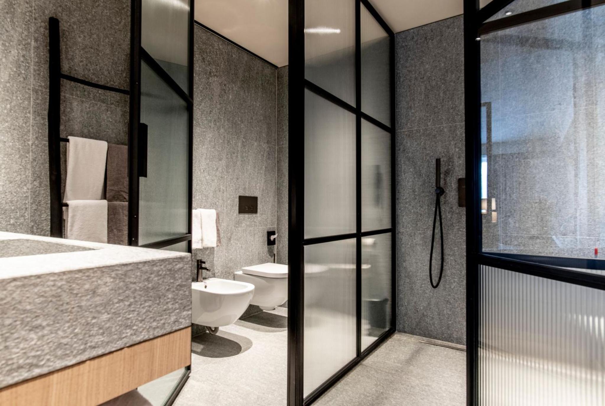 bathroom with a glass shower door and a white toilet