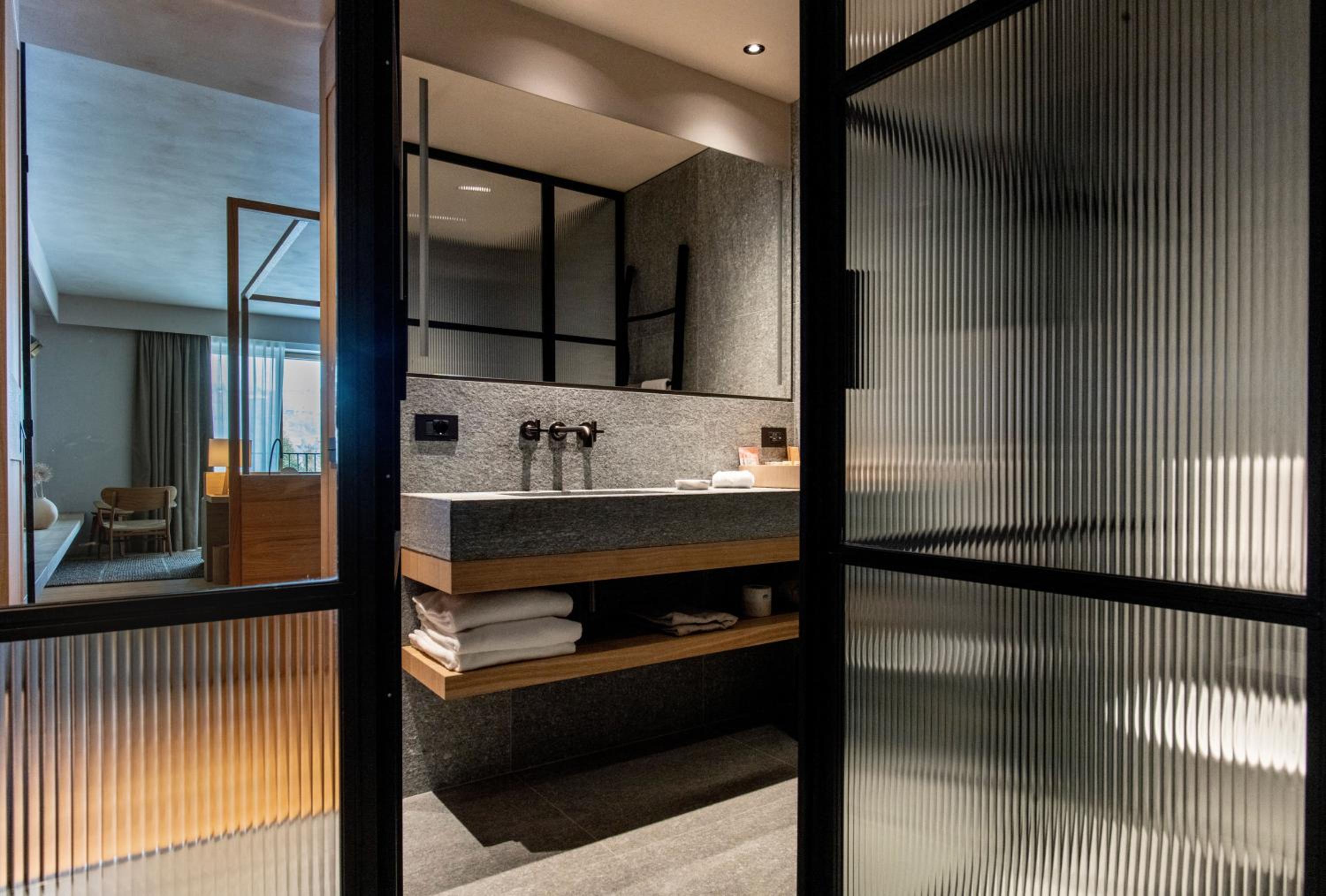 bathroom with a glass door leading to the bath room