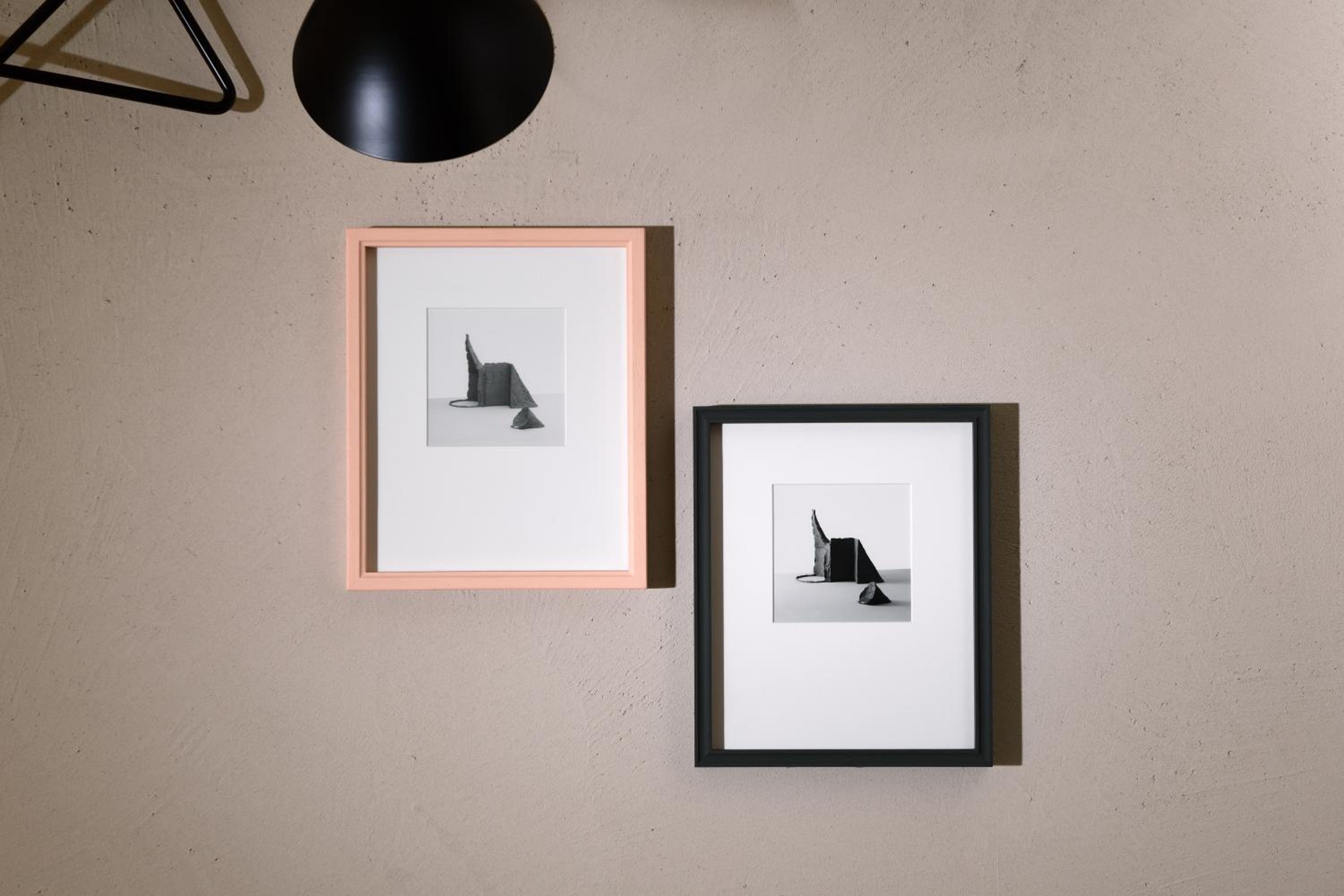 pair of black and white photographs hanging on the wall