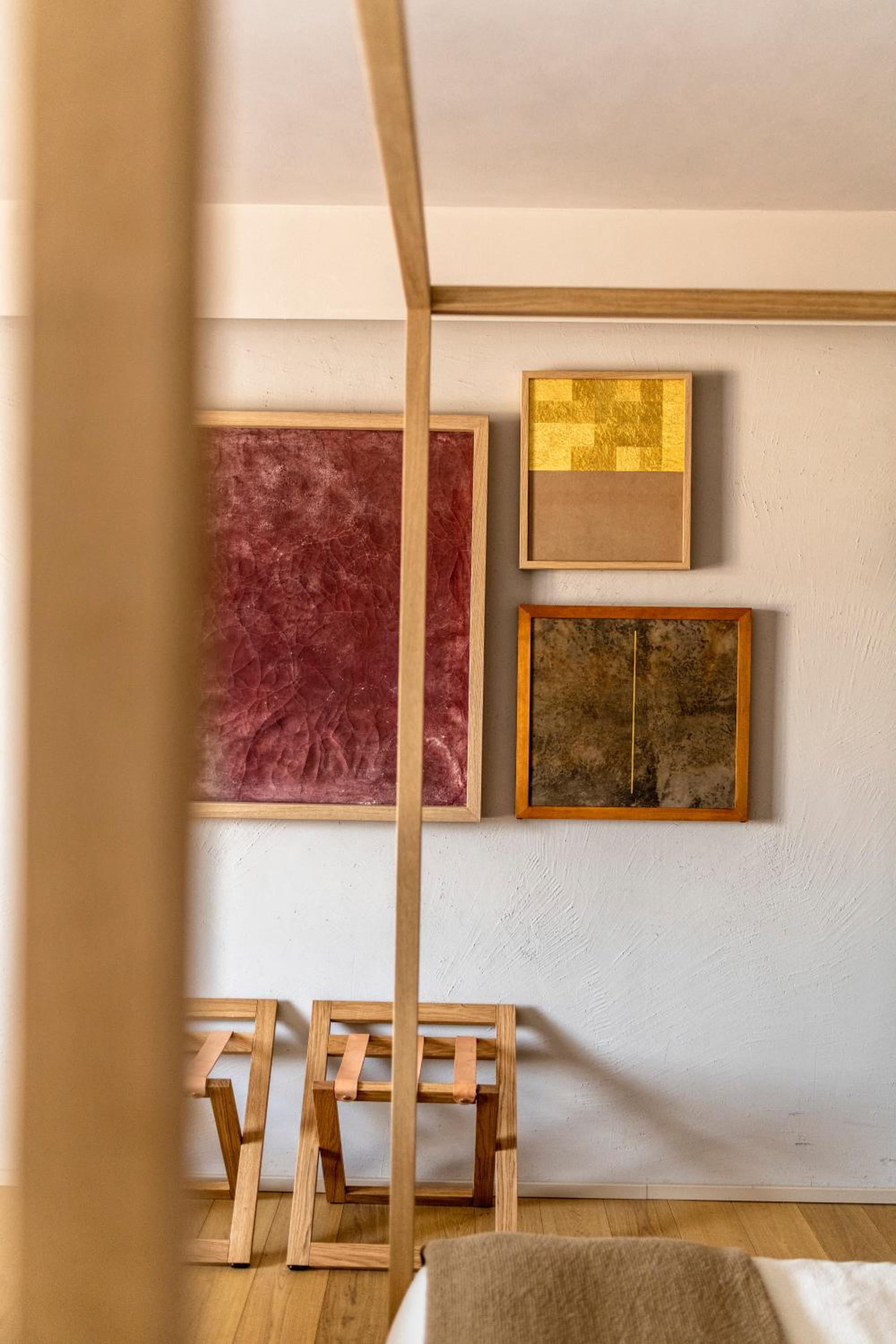 photo of a bedroom with a bed and paintings on the wall