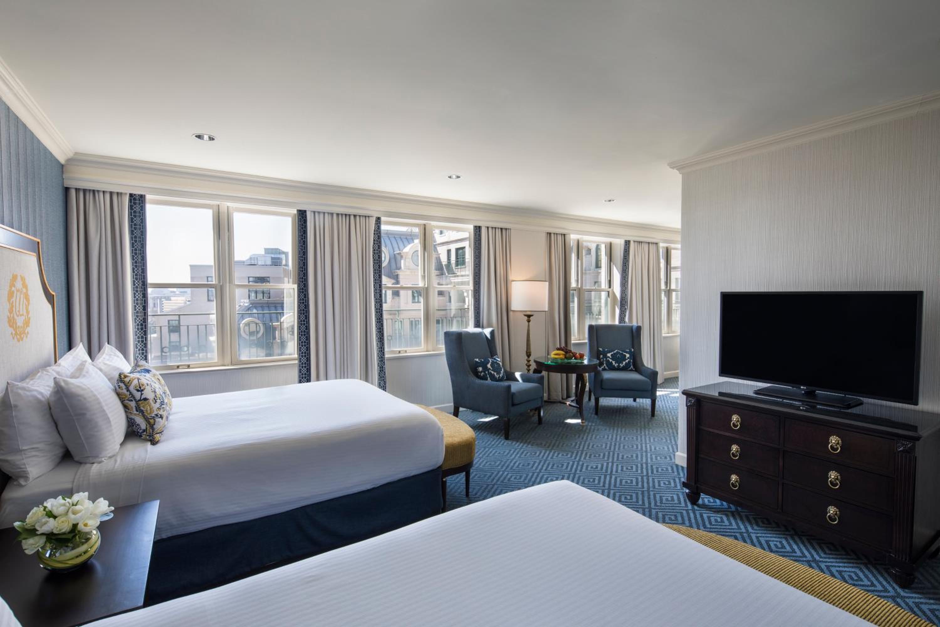 hotel room with two beds and a flat screen tv