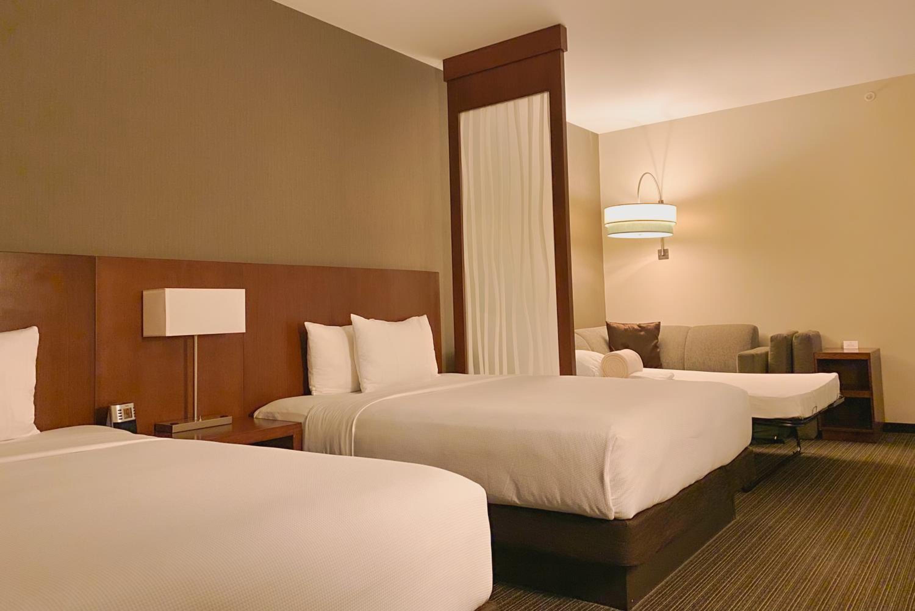 Queen Room with Two Queen Beds and Sofa Bed - Photo 11