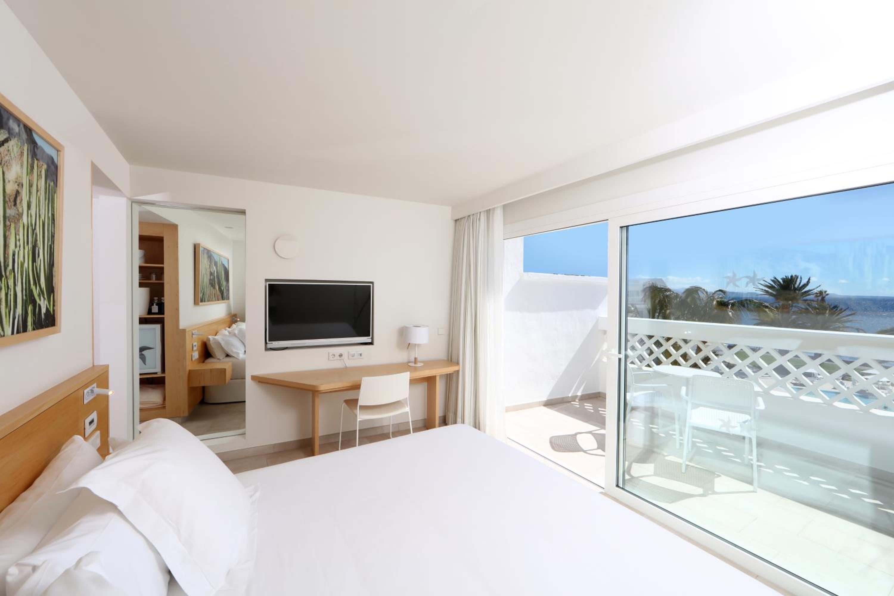 hotel room with a view of the ocean and mountains