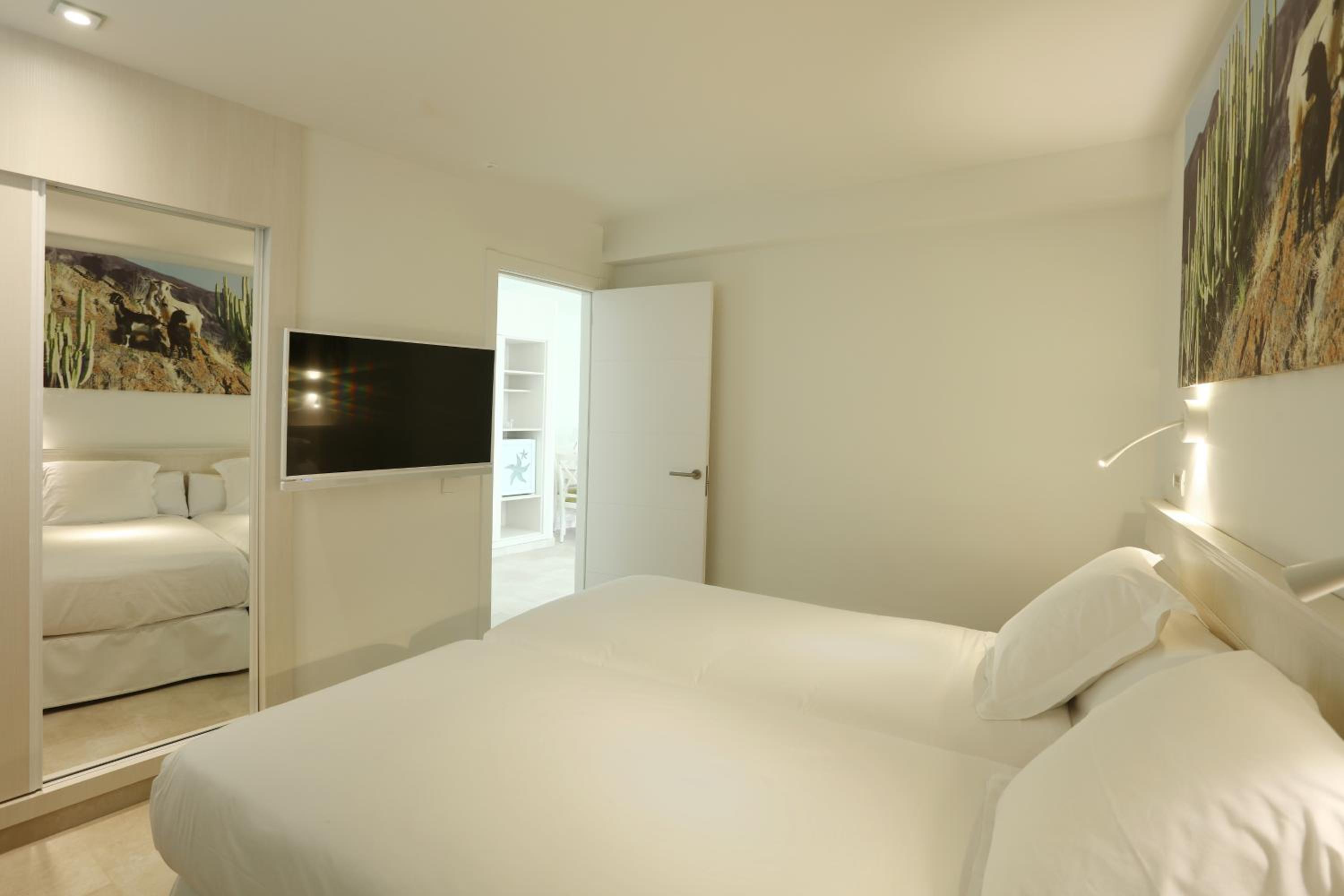 bedroom with a large bed and a flat screen tv