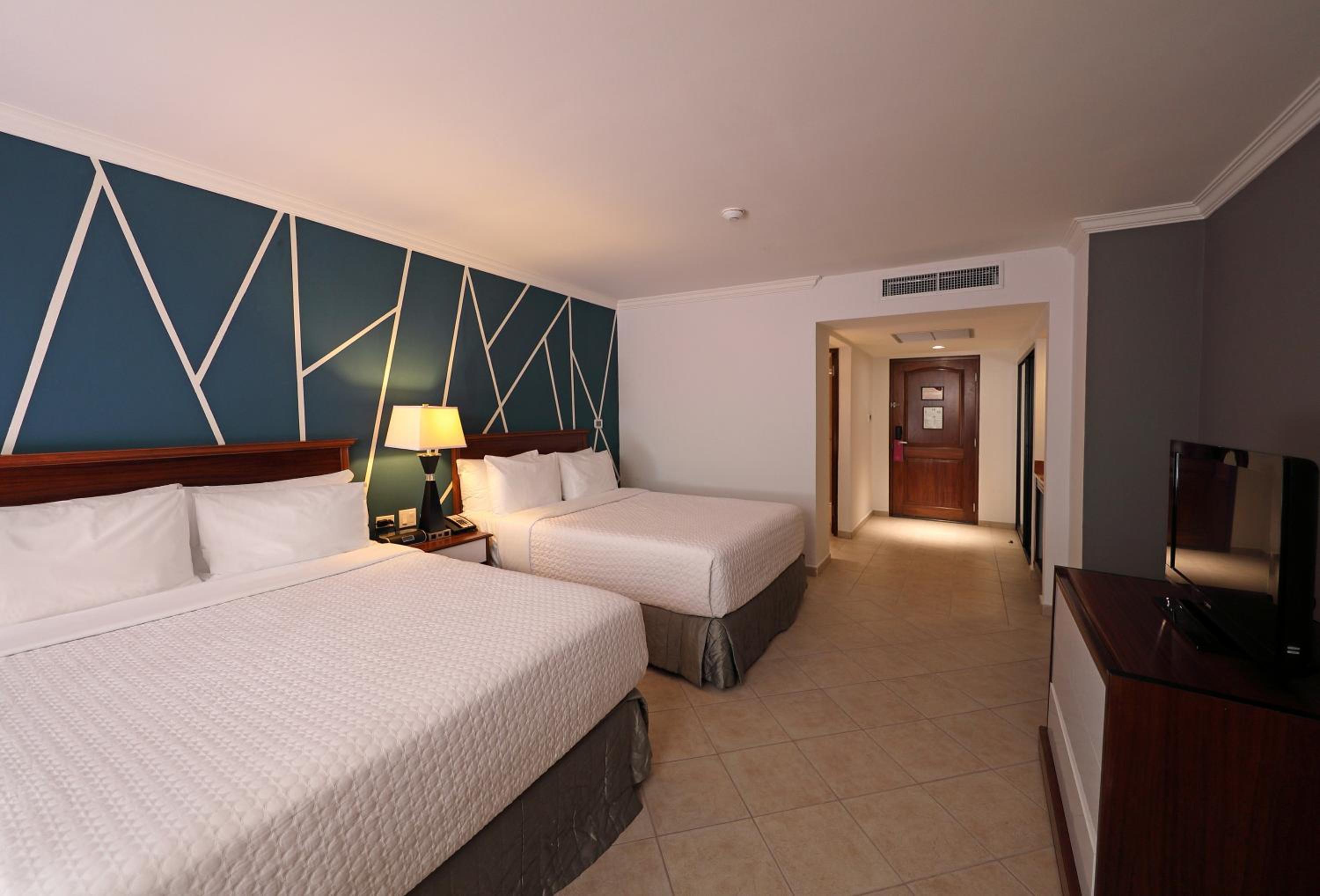 Standard Queen Room with Two Queen Beds and Balcony - Photo 1
