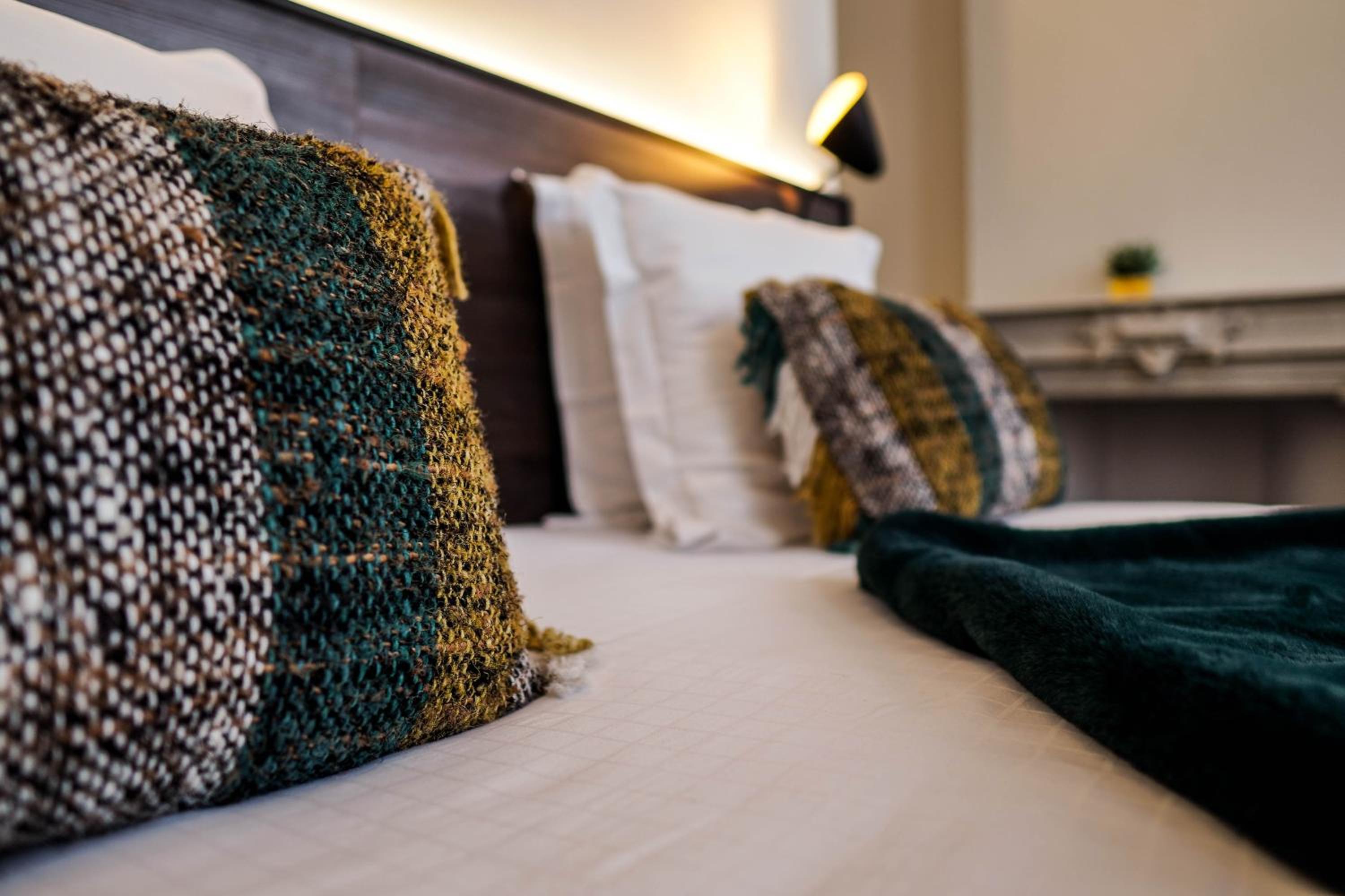 closeup of the pillows and blankets on the bed