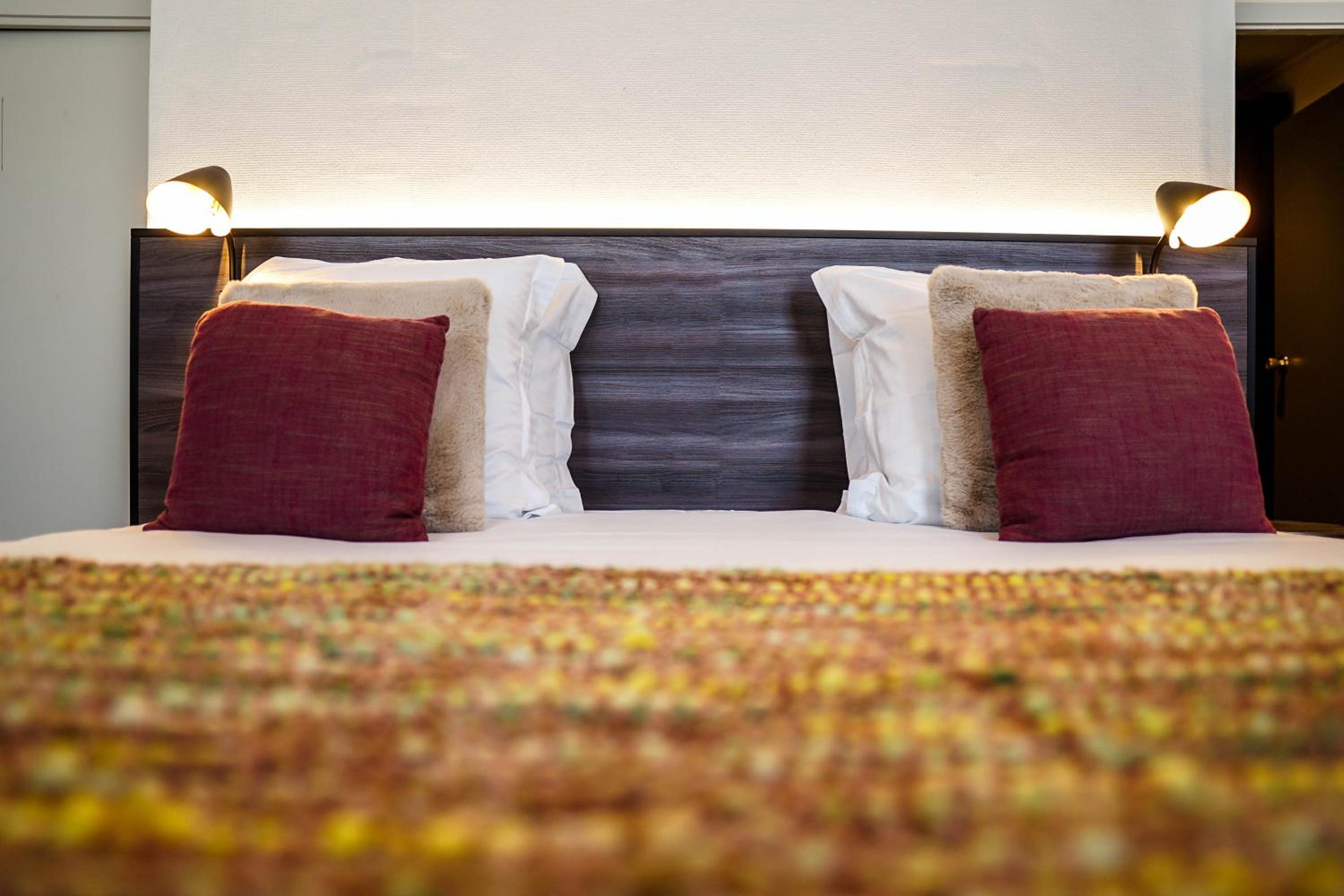 close up of a bed with two pillows on it