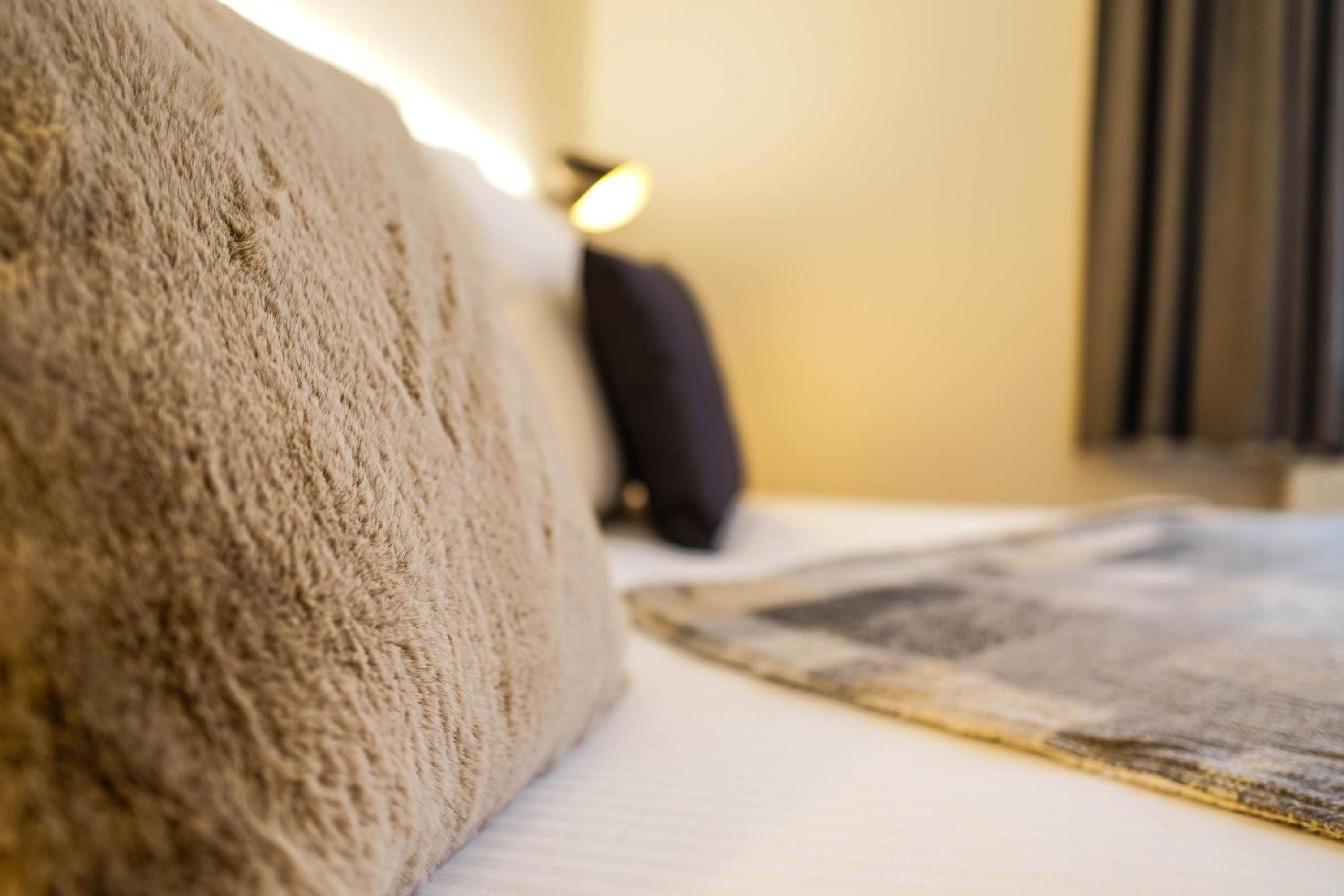 close up of a bed with a pillow on it