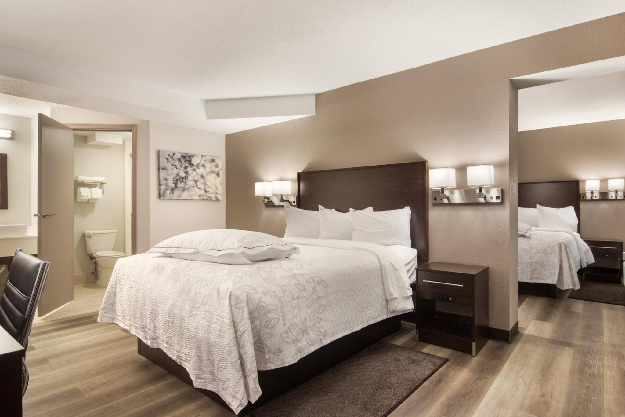 Premium Suite with Three Queen Beds with Kitchenette Smoke Free (Upgraded Bedding and Snack Box) - Photo 1