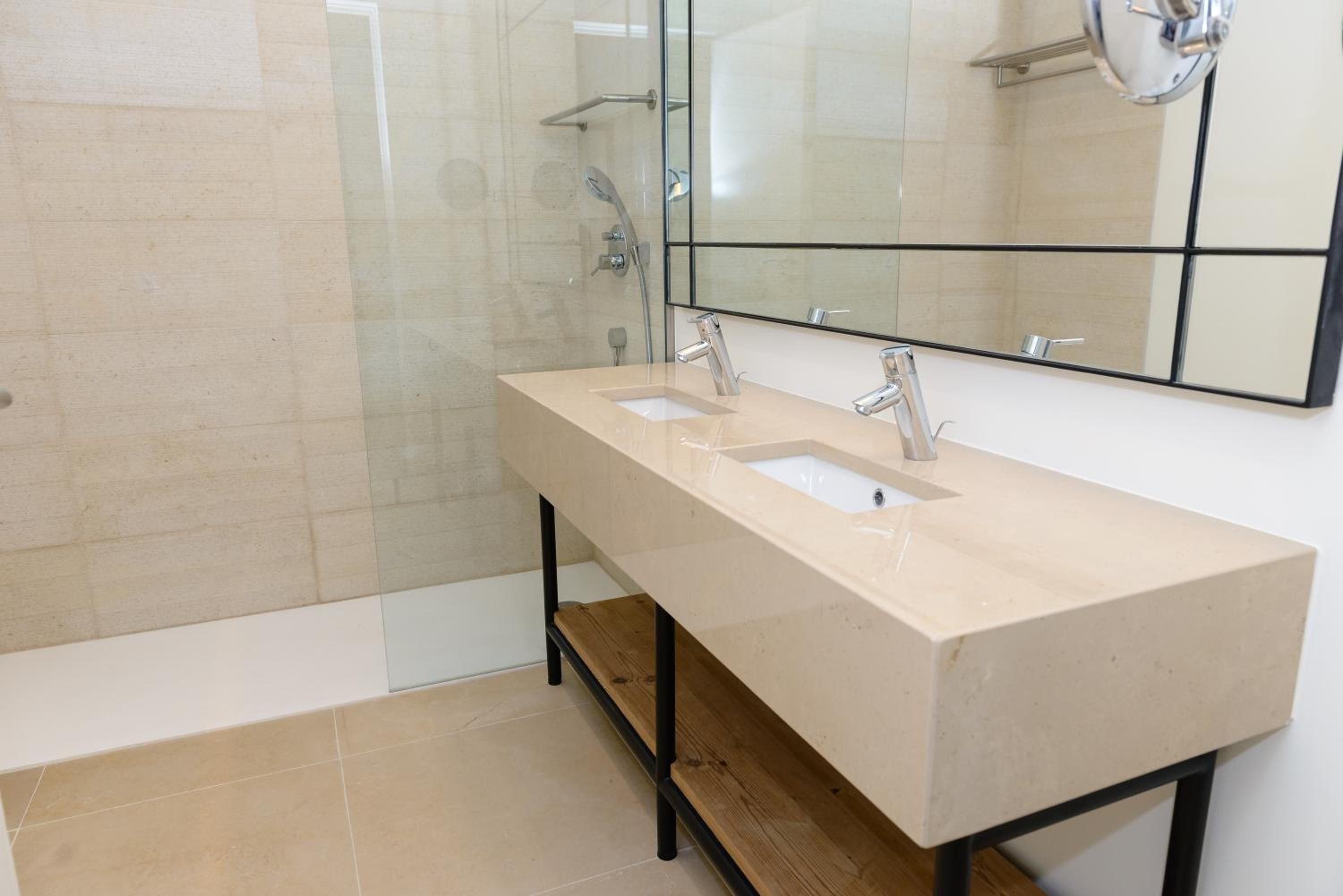 bathroom with two sinks and a walk - in shower