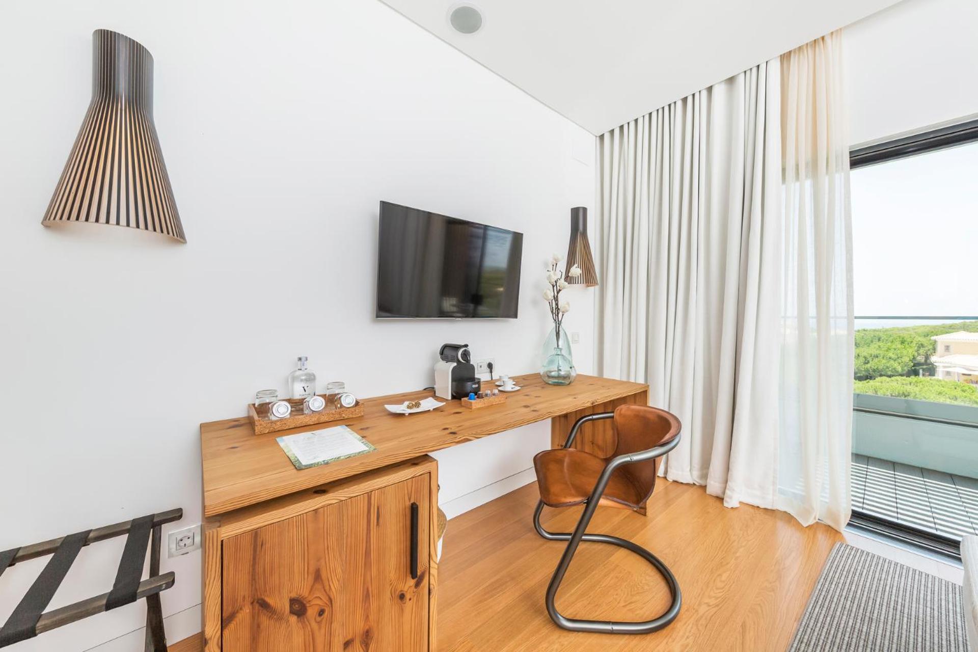 room with a desk, chair, and flat screen tv