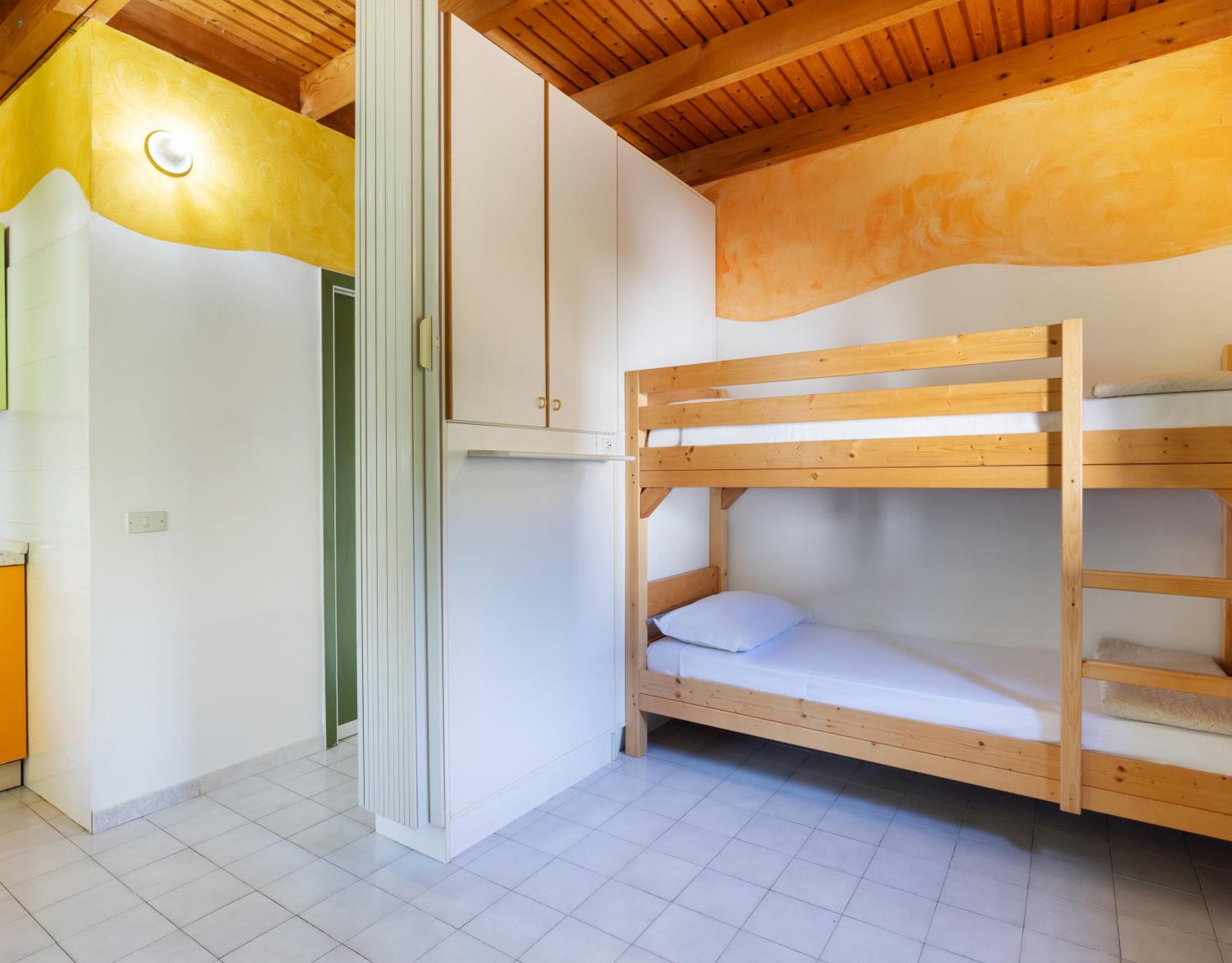 Bungalow - Lake (Pool View) - Ground floor with air conditioning, one double room and one open space with bunk bed. First floor one twin room, no air conditioning - NO PETS ALLOWED