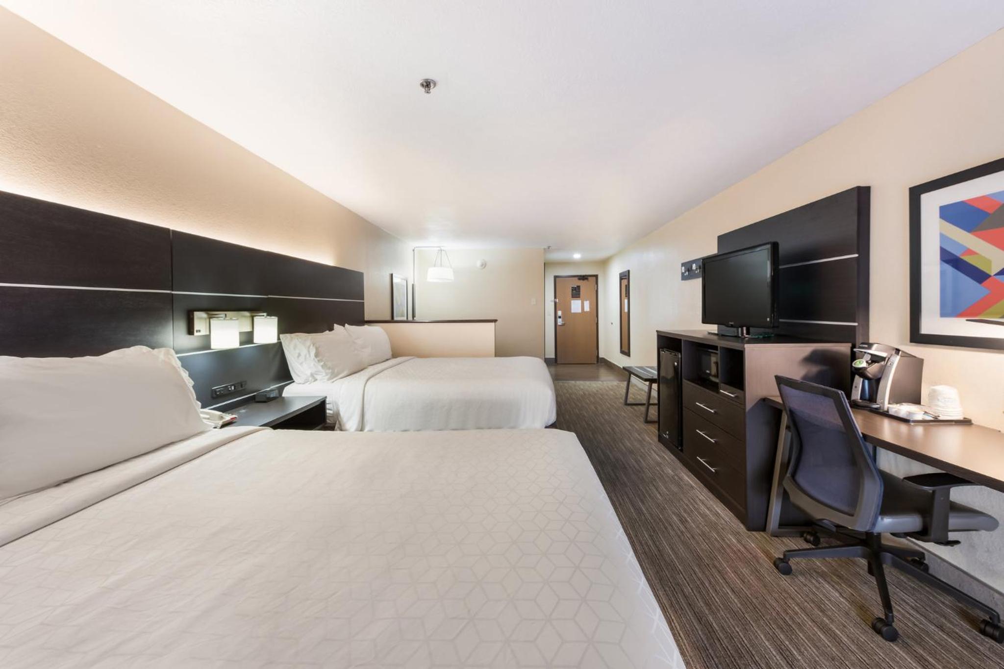 hotel room with two beds and a flat screen tv