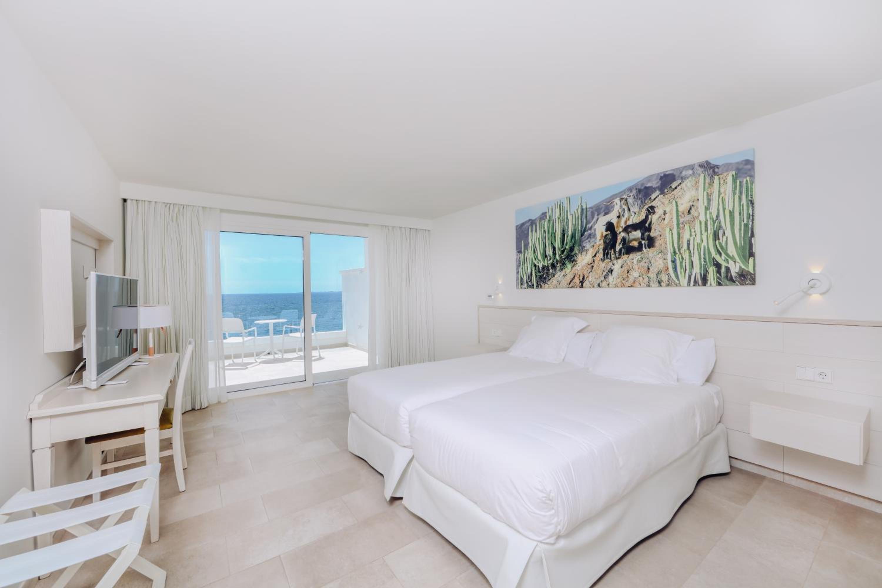 hotel room with two beds and a view of the ocean