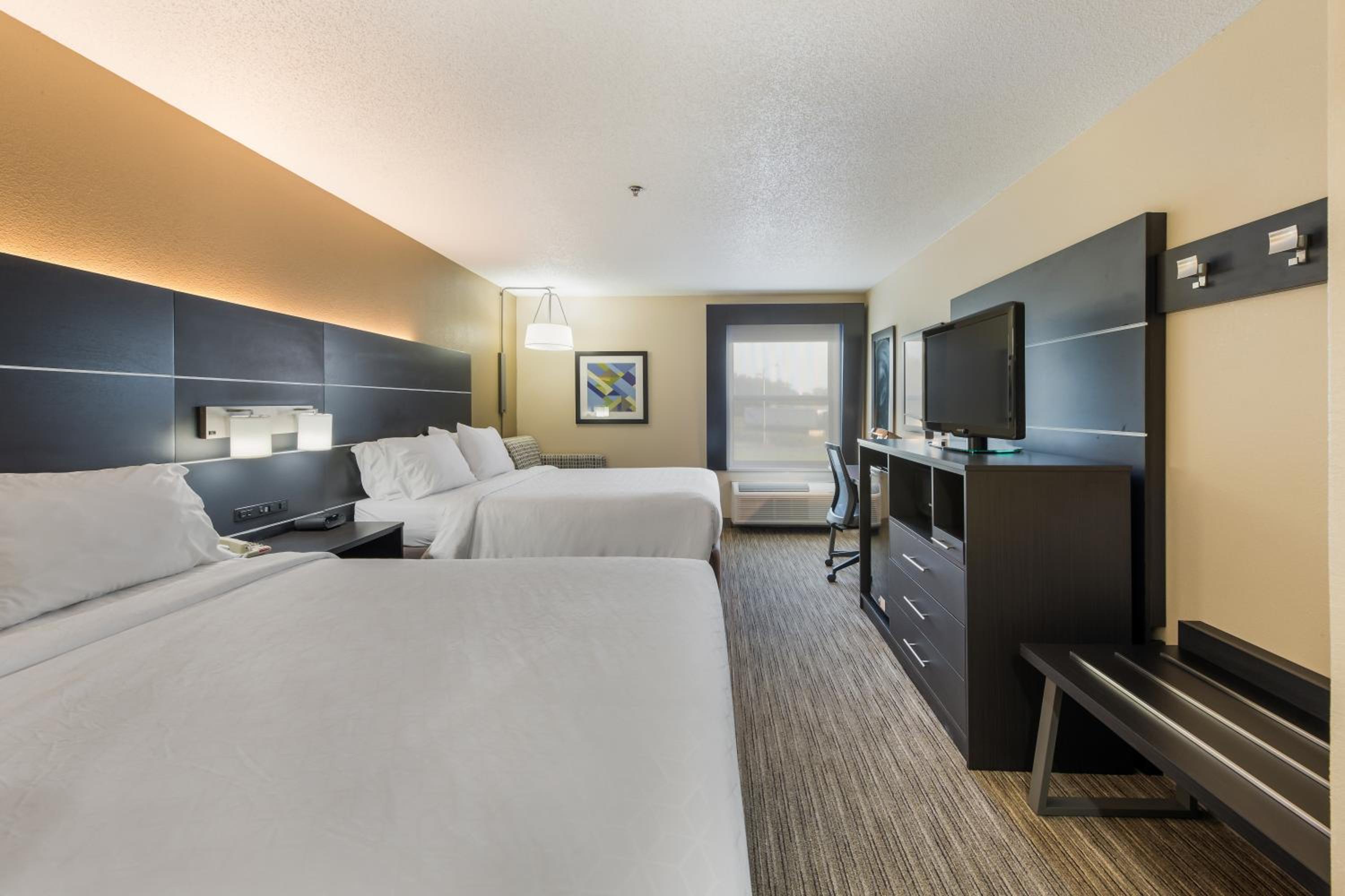 hotel room with two beds and a flat screen tv