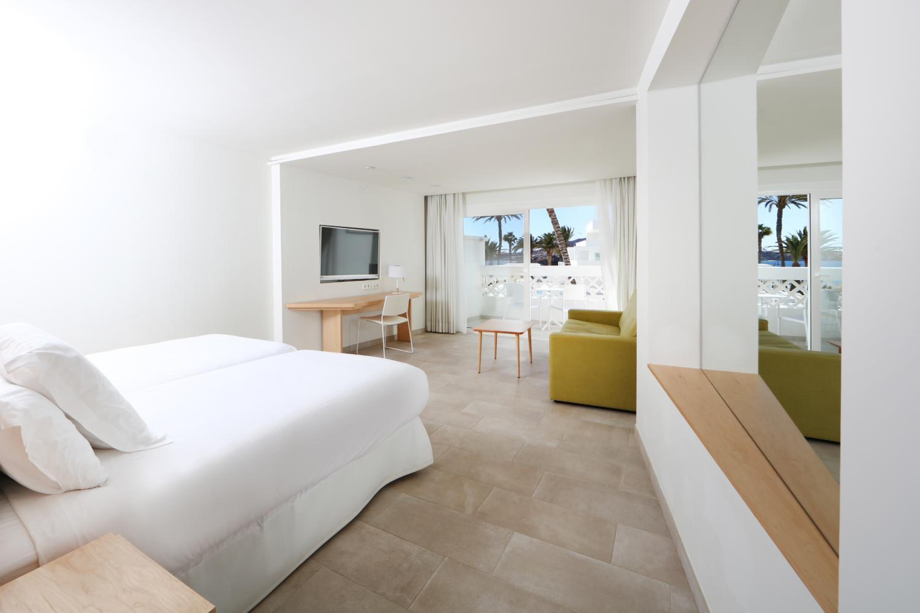 hotel room with a large bed and a flat screen tv