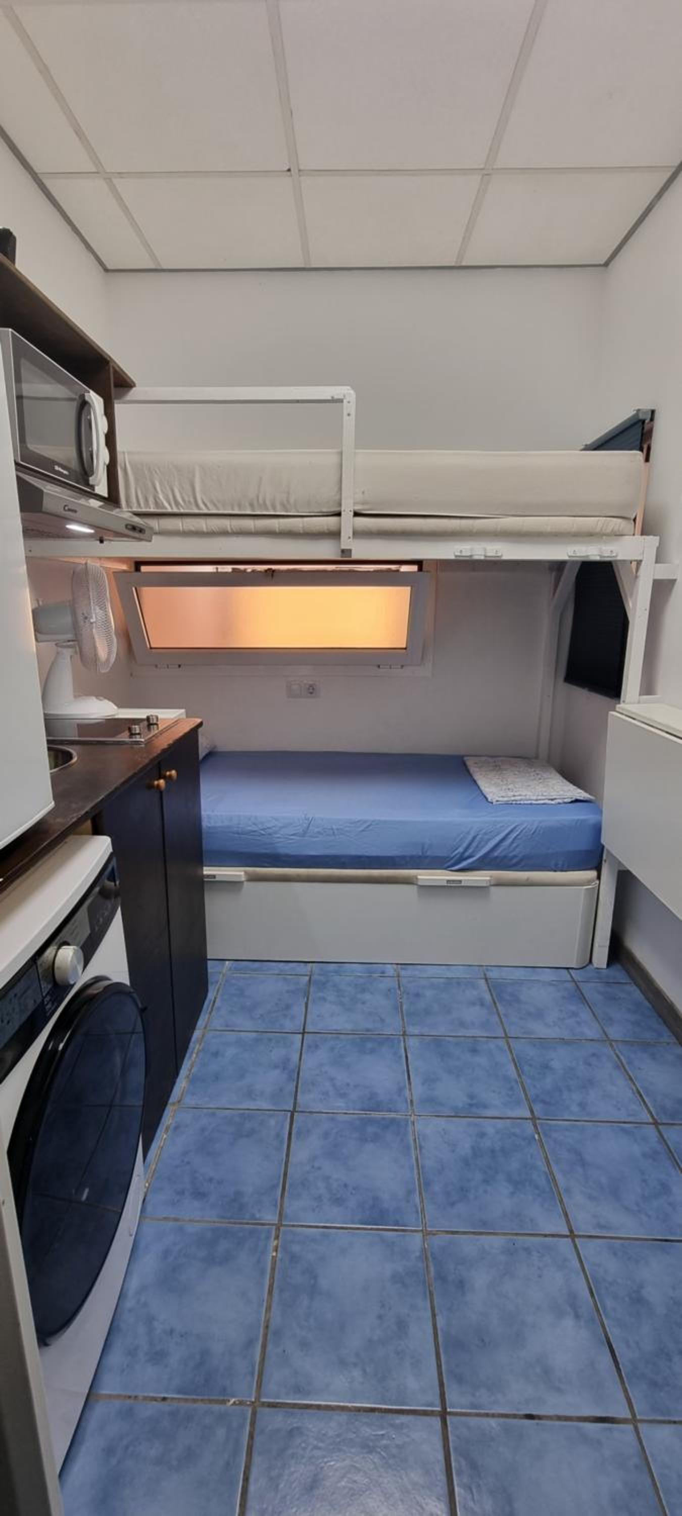 Small room with bunk beds with interior window