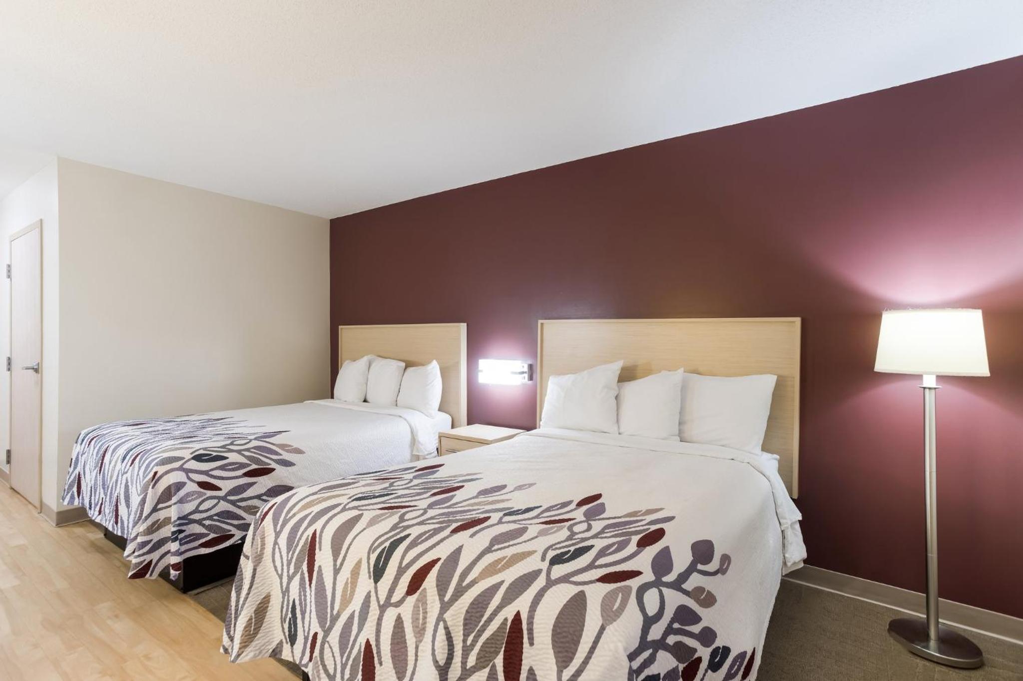 hotel room with two beds and a flat screen tv