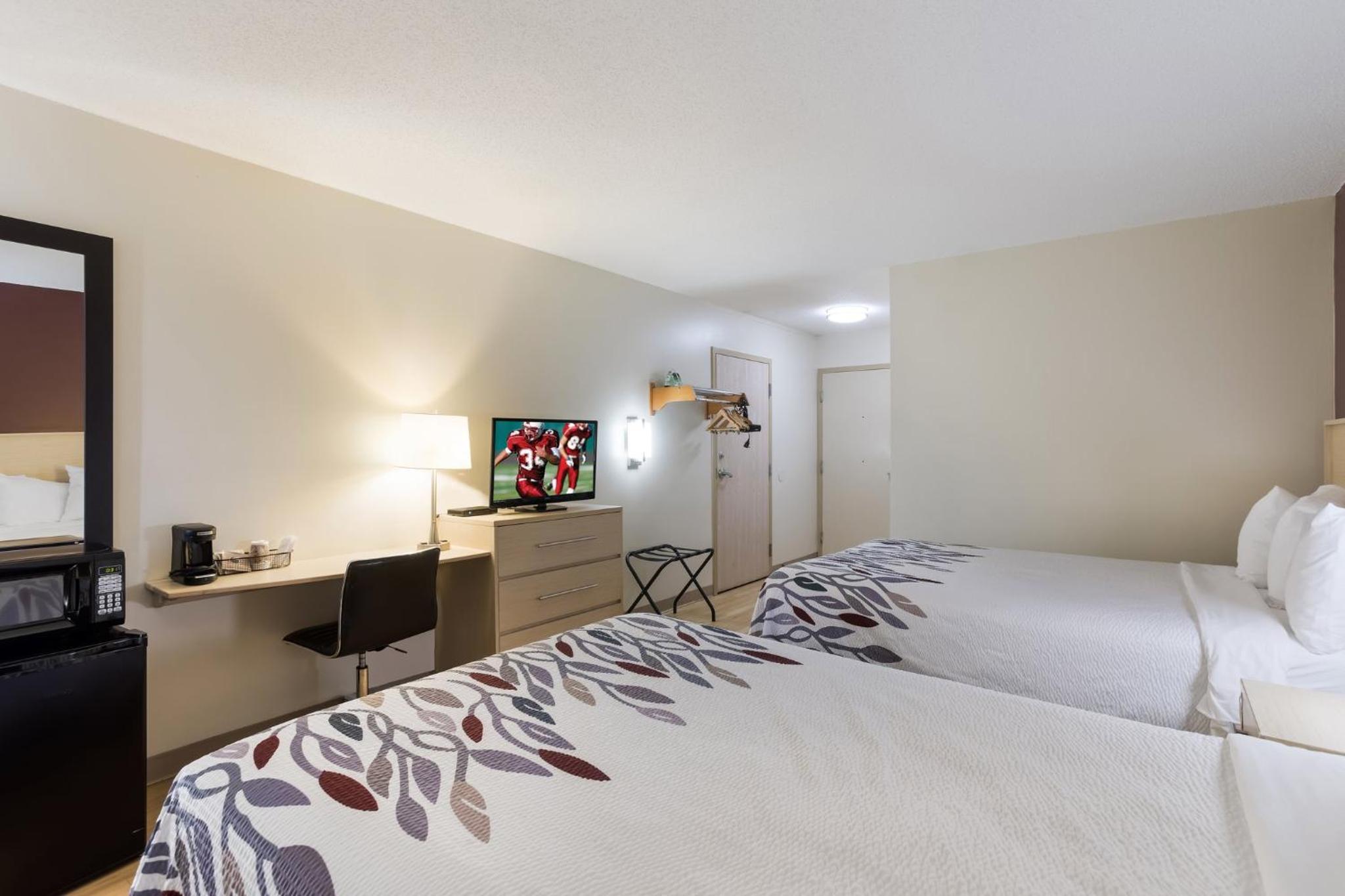 hotel room with two beds and a flat screen tv
