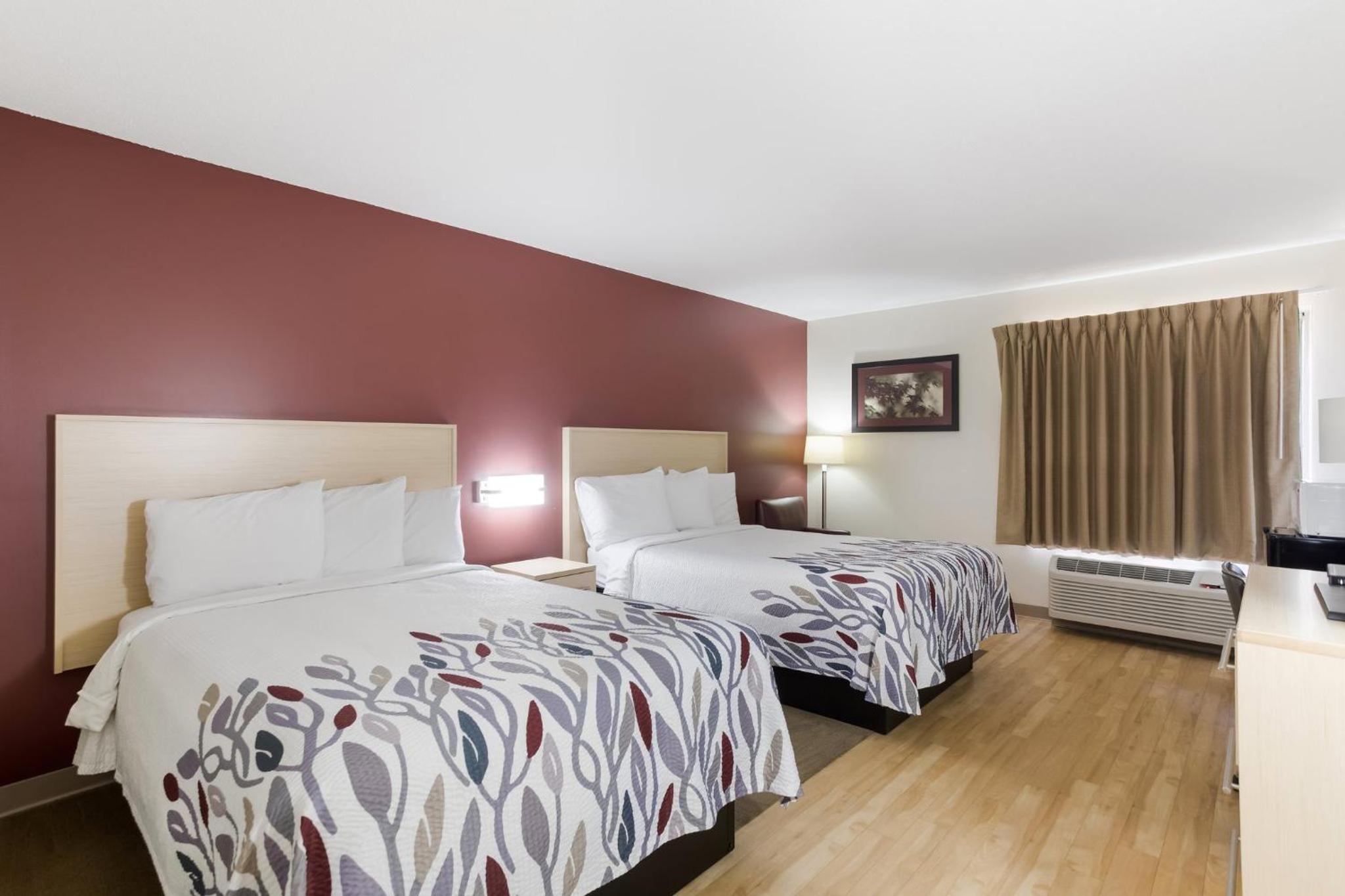 hotel room with two beds and a flat screen tv