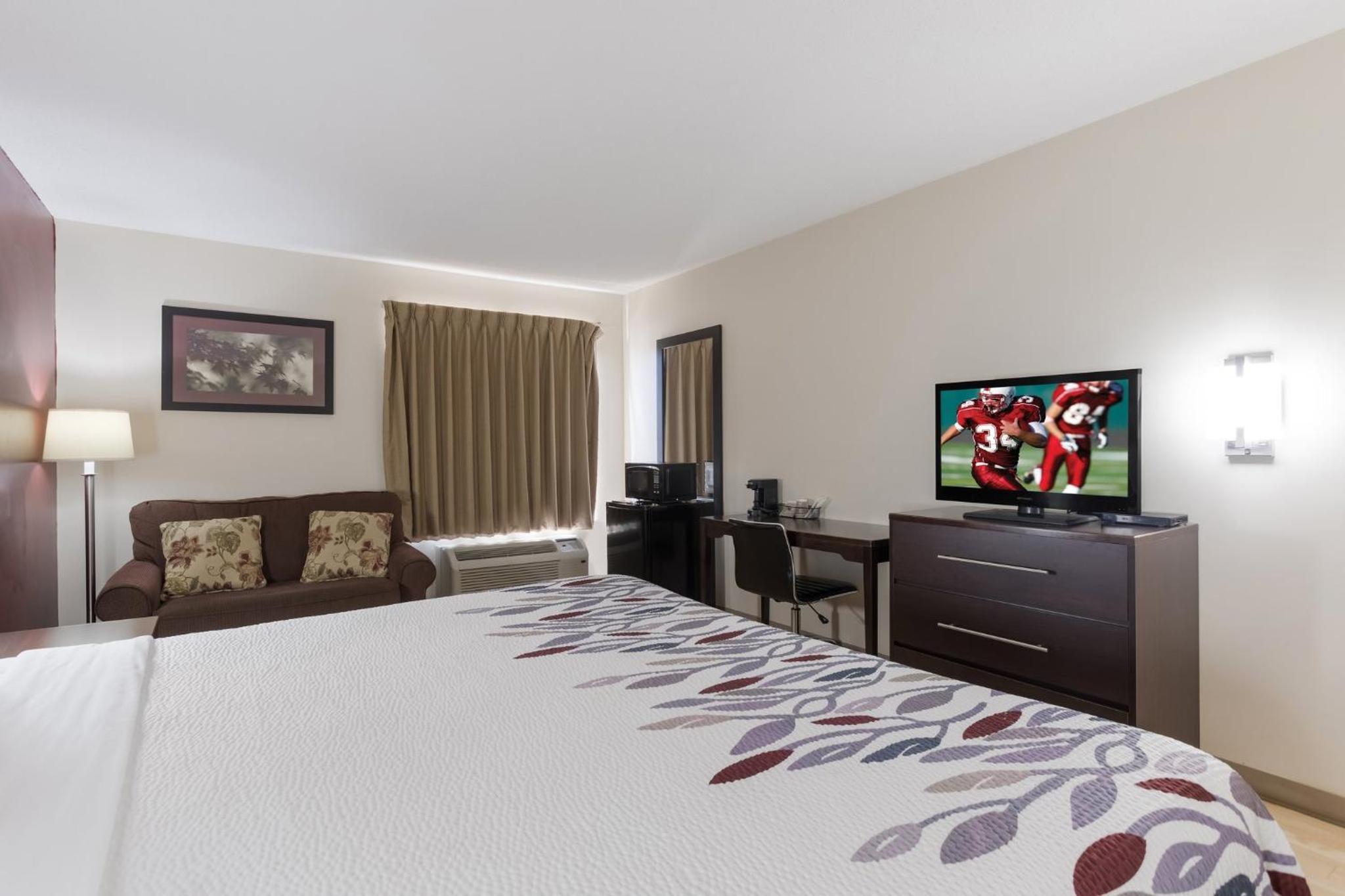 hotel room with a large bed and a flat screen tv