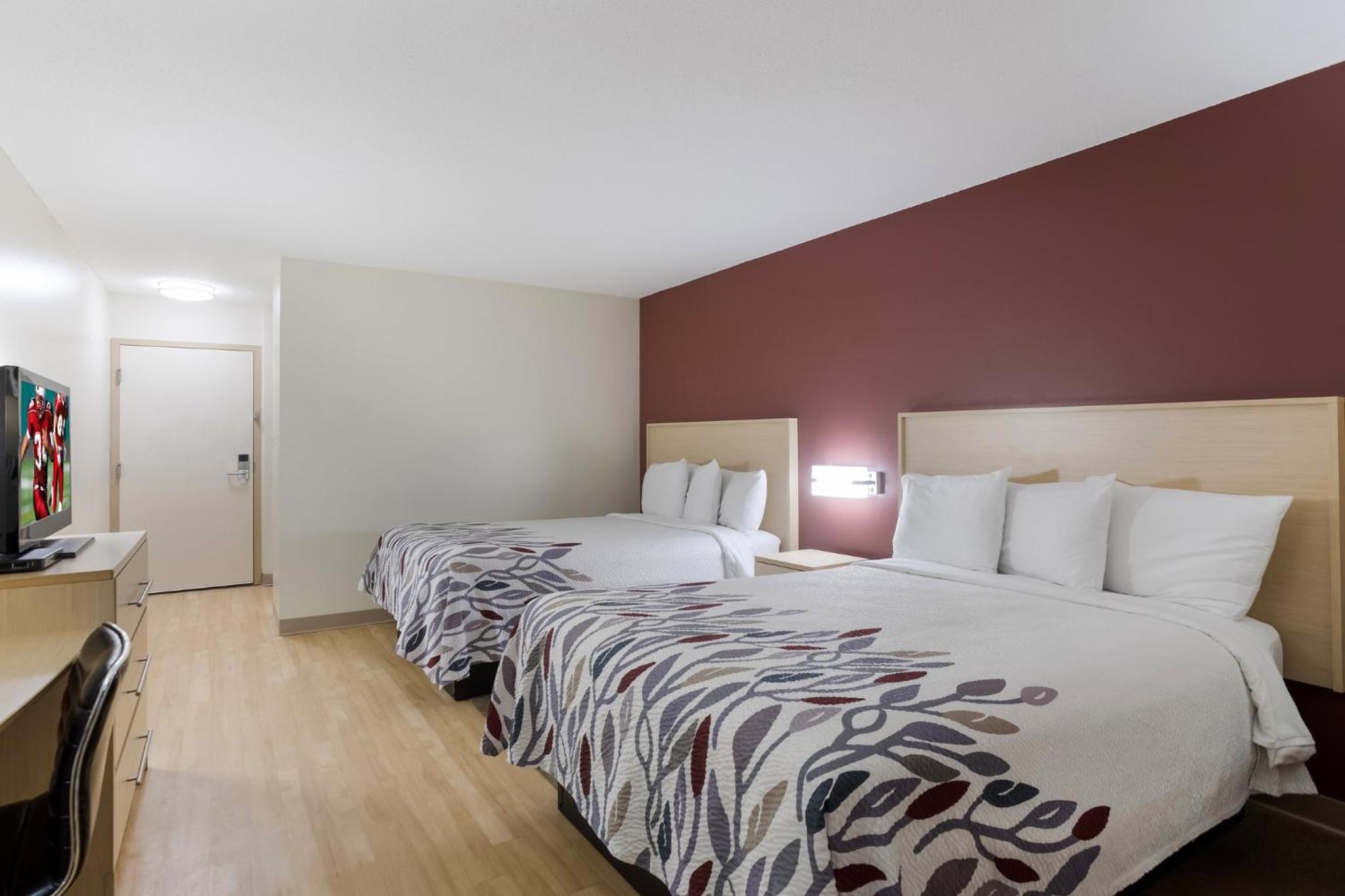 hotel room with two beds and a flat screen tv
