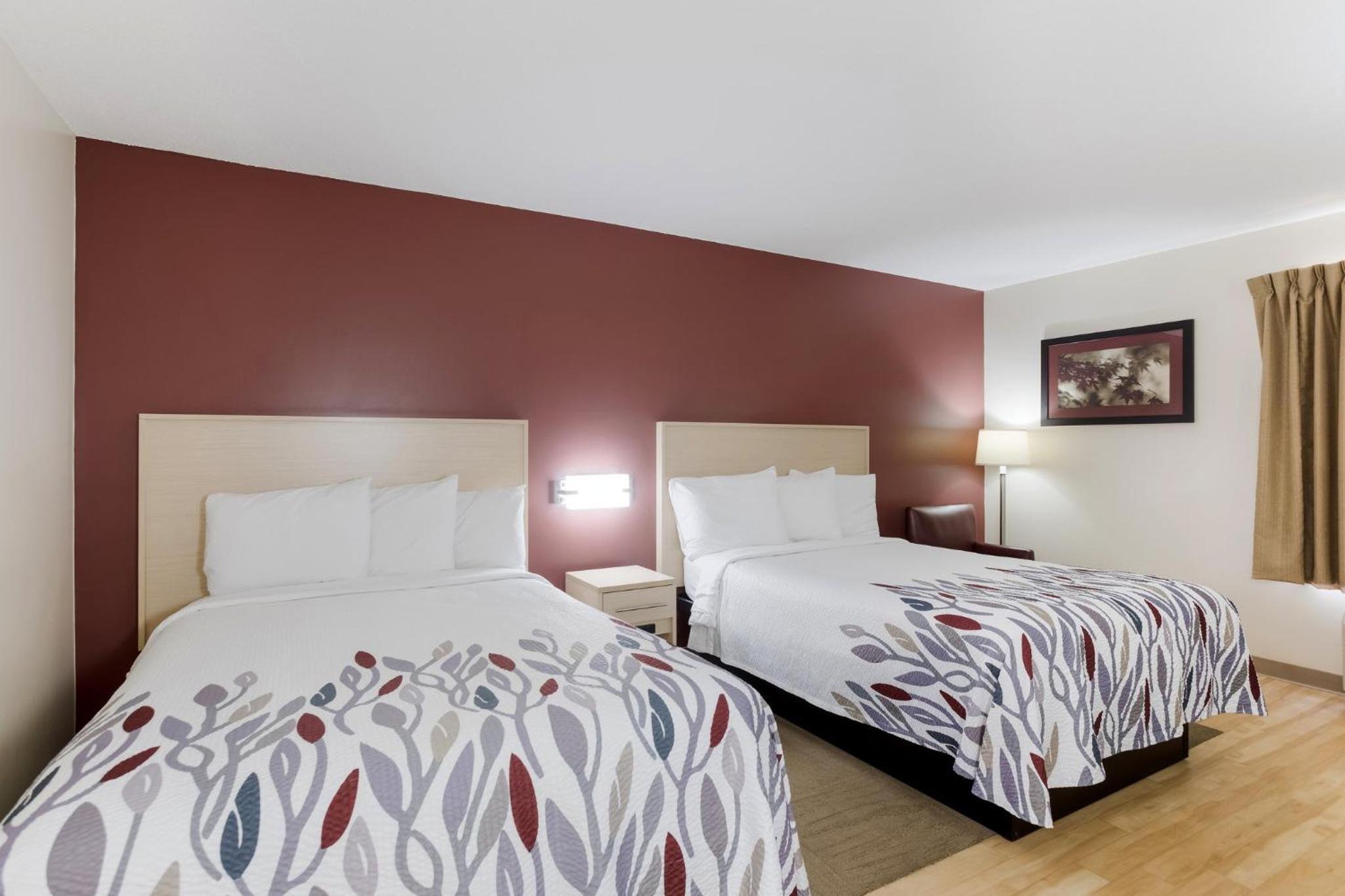hotel room with two beds and a flat screen tv