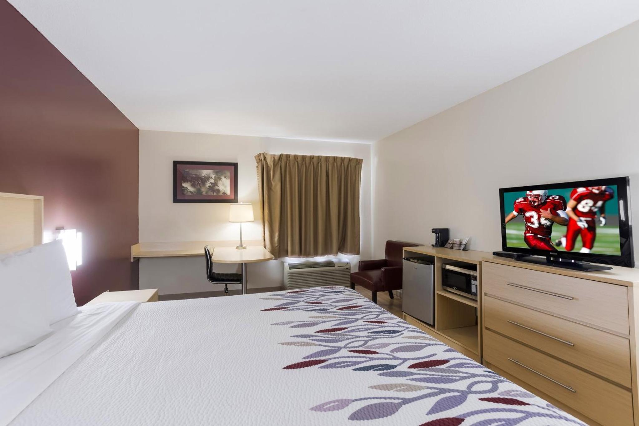hotel room with a large bed and a flat screen tv