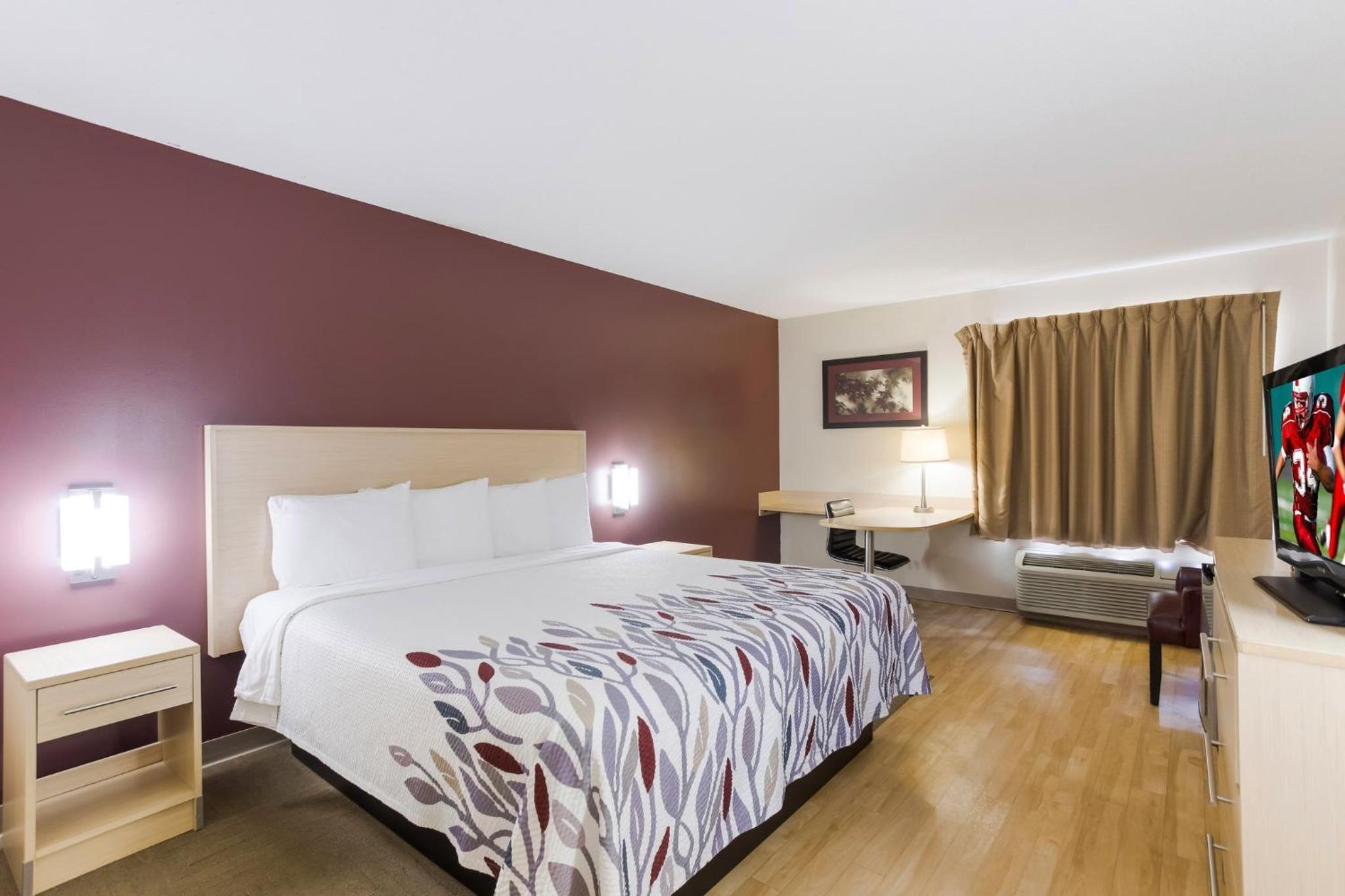 hotel room with a bed and a flat screen tv