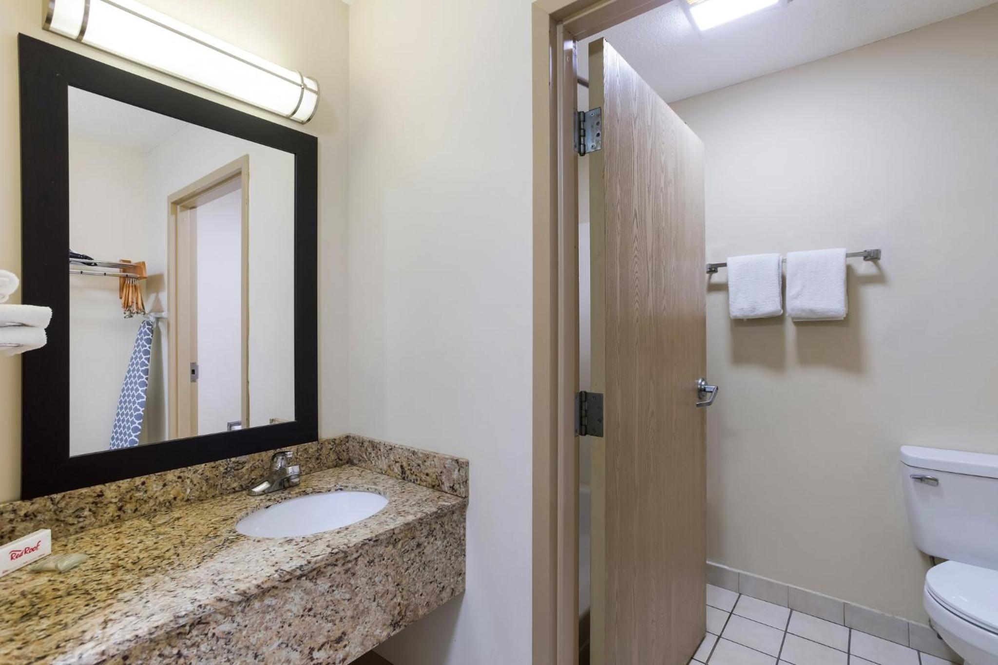 bathroom with granite counter tops and a marble vanity top