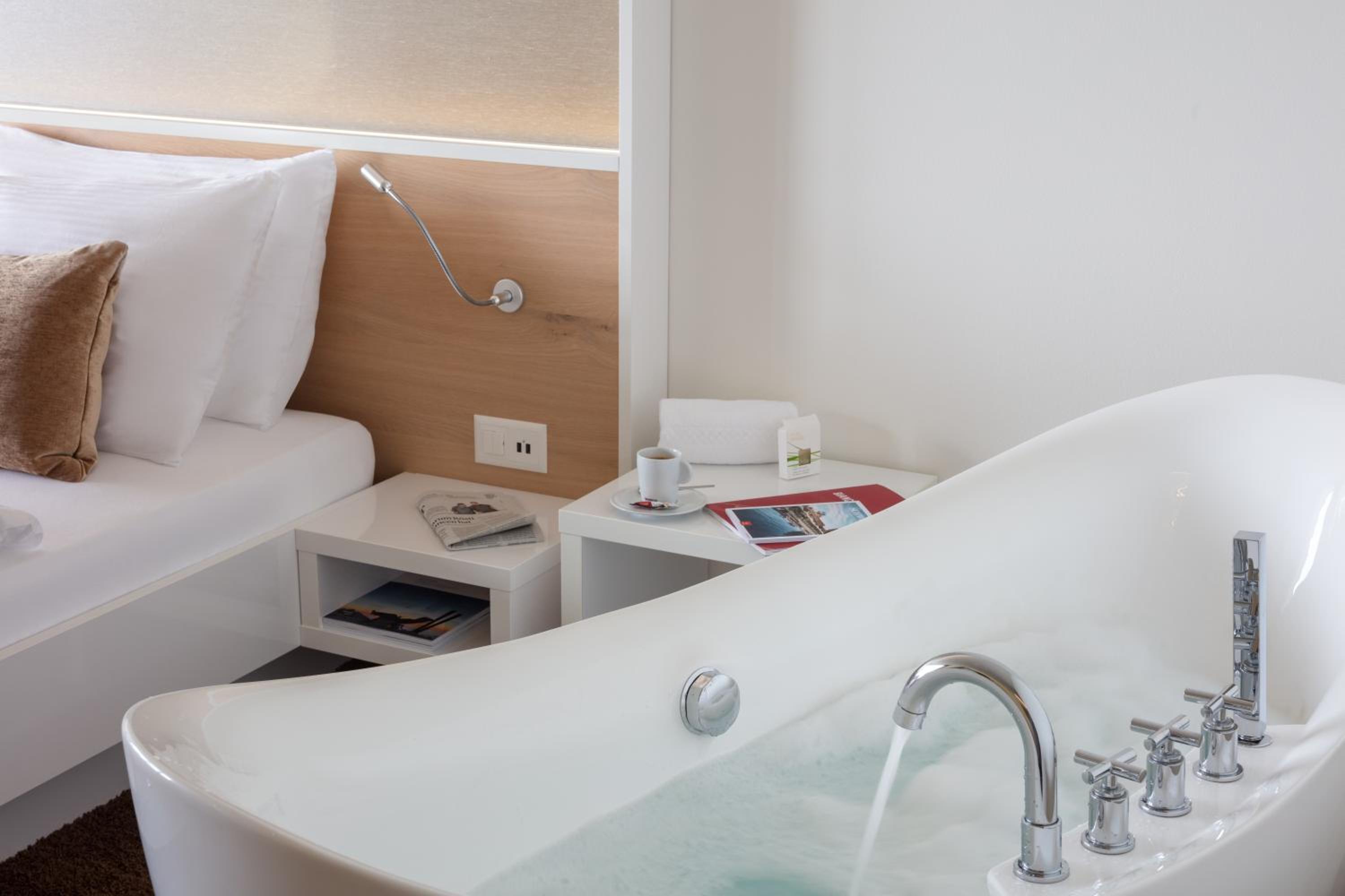 hotel room with a bathtub in the foreground