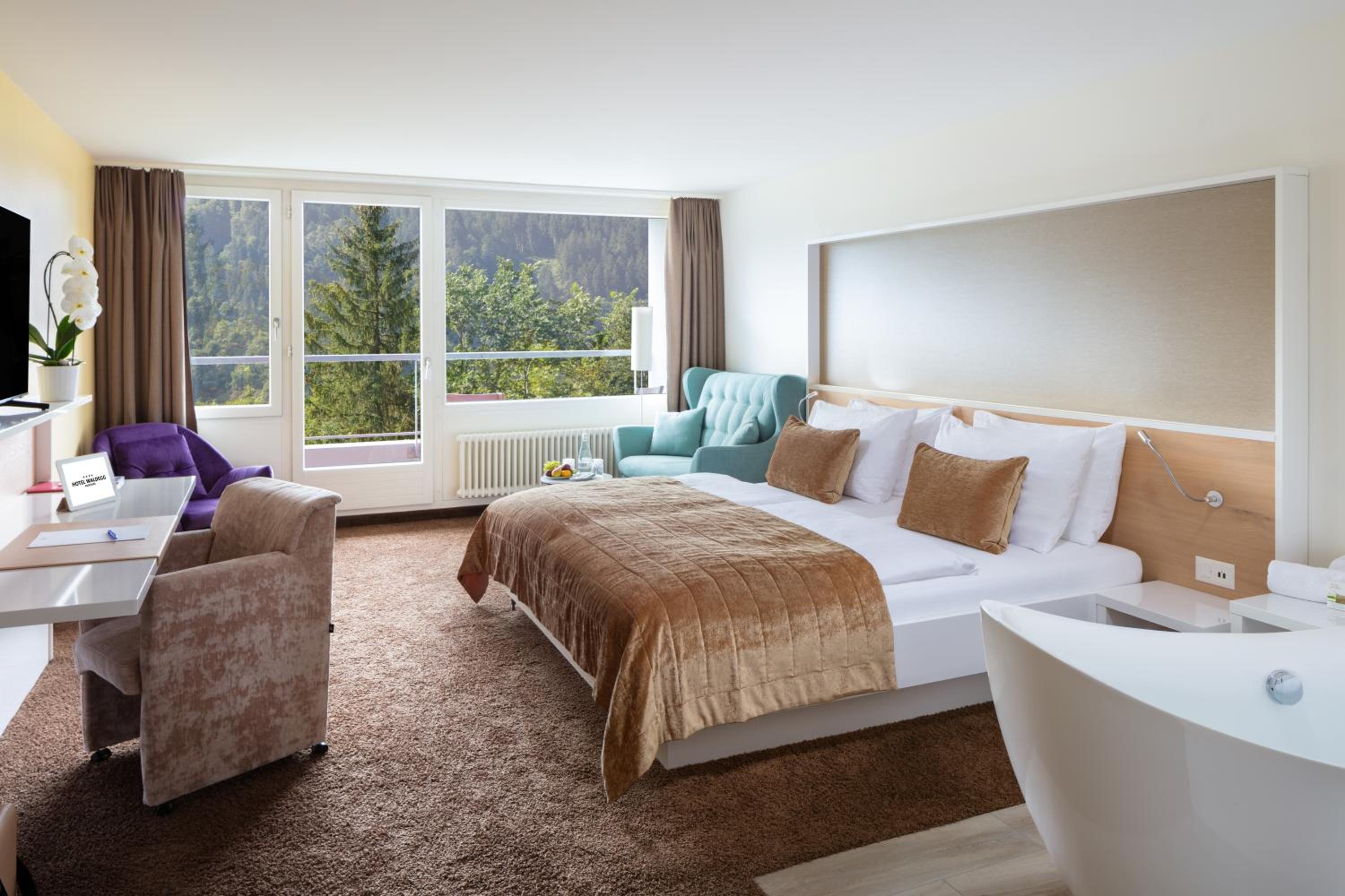 hotel room with a large bed and a bathtub